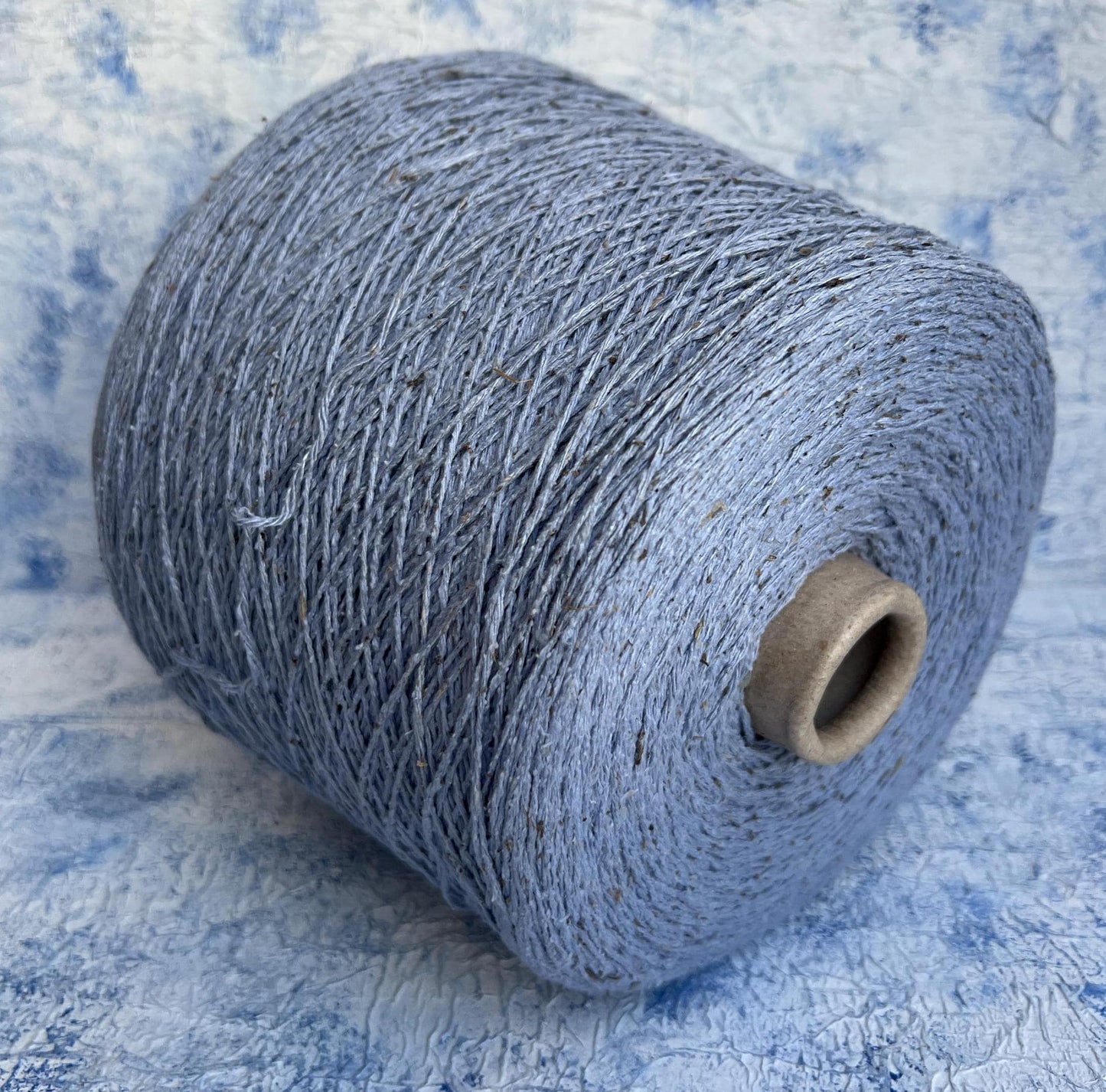 Silk Bourette yarn on cone 100%,Nm 4000, Color Light Blue.Per 100 gr