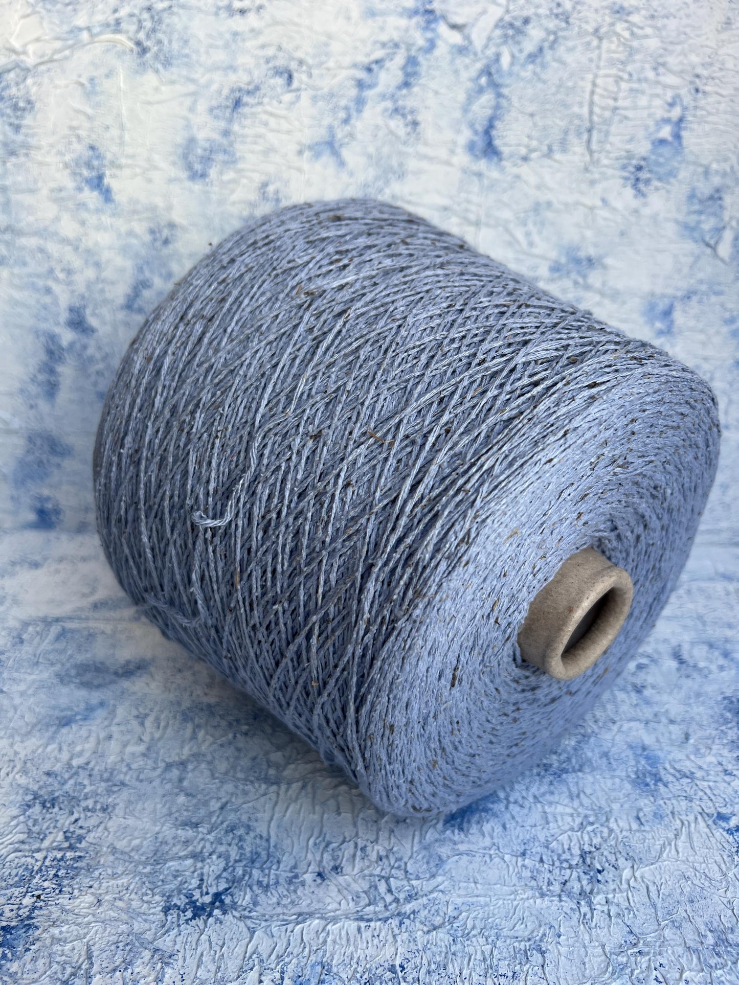 Silk Bourette yarn on cone 100%,Nm 4000, Color Light Blue.Per 100 gr