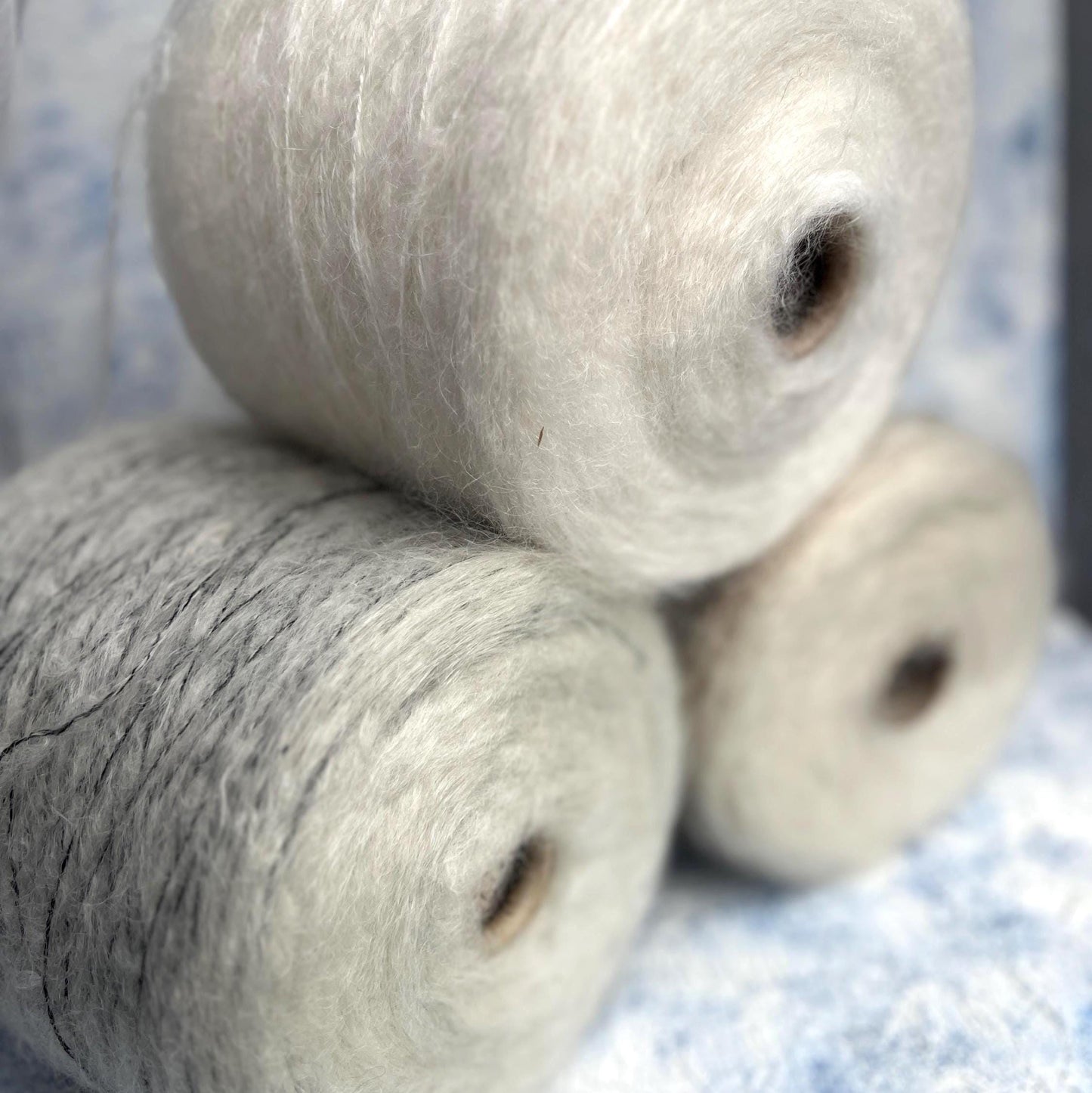 70% Kid Mohair&15% Wool,15% PA yarn on cone. White&Black.Per 100 gr