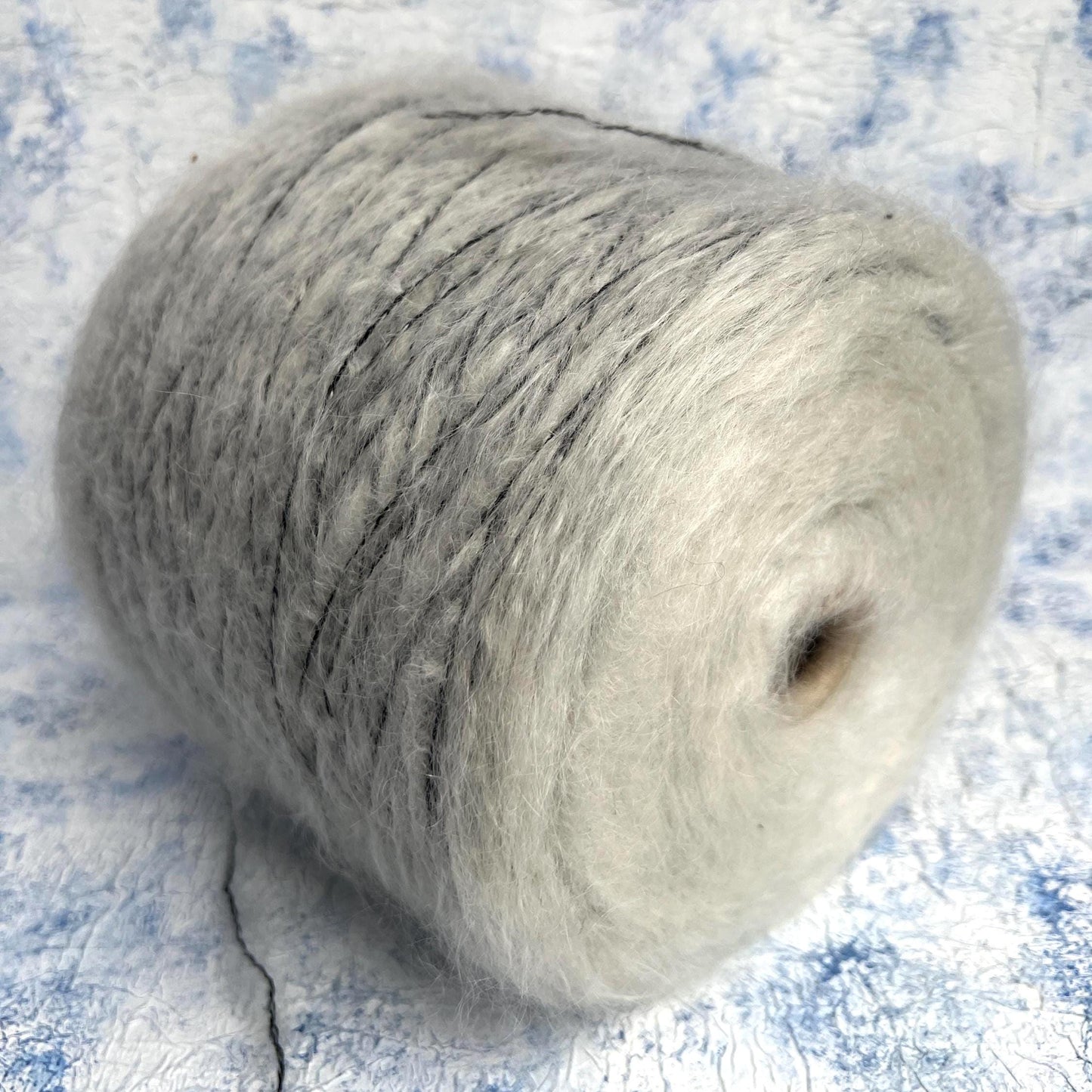 70% Kid Mohair&15% Wool,15% PA yarn on cone. White&Black.Per 100 gr
