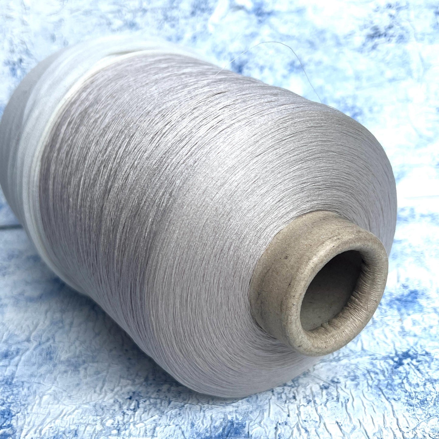 Silk yarn for knitting 100%,Pecci yarn on cone, Color Llight Gray. Per 100 gr