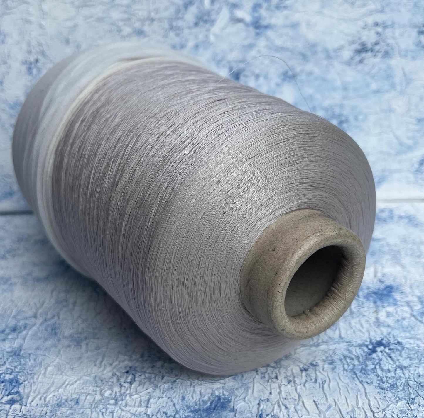 Silk yarn for knitting 100%,Pecci yarn on cone, Color Llight Gray. Per 100 gr
