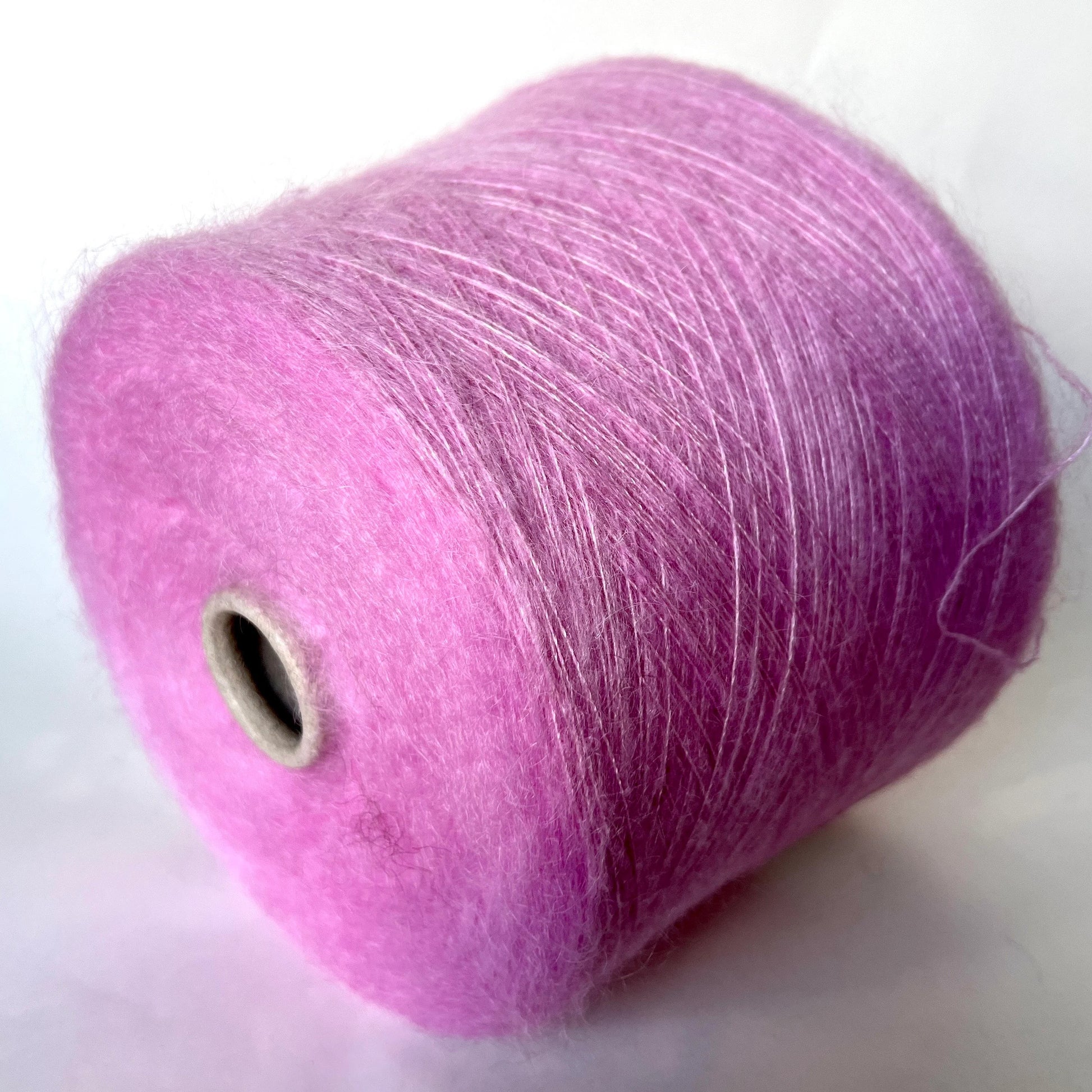 Super Kid Mohair Yarn & Poliamide Yarn. Yarn on Cone. Art: GLOPIA. Fibre: 70% Super kid mohair Yarn & 30% Poliamide Yarn. Color: Rosa. This is a luxurious yarn, very soft and fluffy yarn with a wonderful composition yarn of 70% Super Kid mohair yarn and 30% Poliamide yarn.