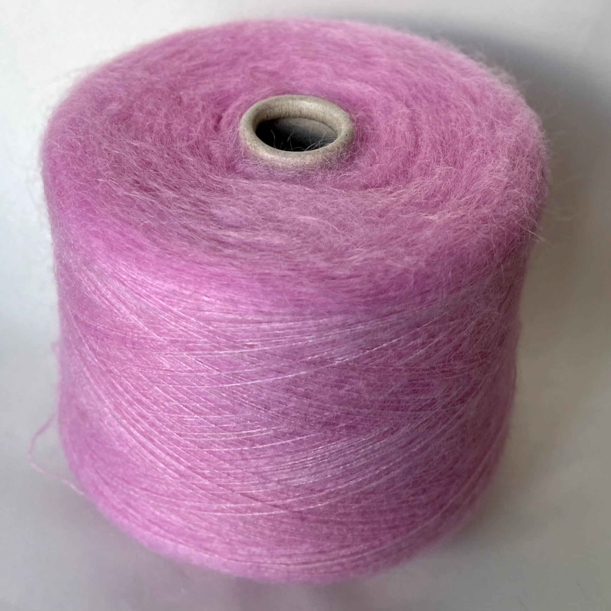 Super Kid Mohair Yarn & Poliamide Yarn. Yarn on Cone. Art: GLOPIA. Fibre: 70% Super kid mohair Yarn & 30% Poliamide Yarn. Color: Rosa. This is a luxurious yarn, very soft and fluffy yarn with a wonderful composition yarn of 70% Super Kid mohair yarn and 30% Poliamide yarn.