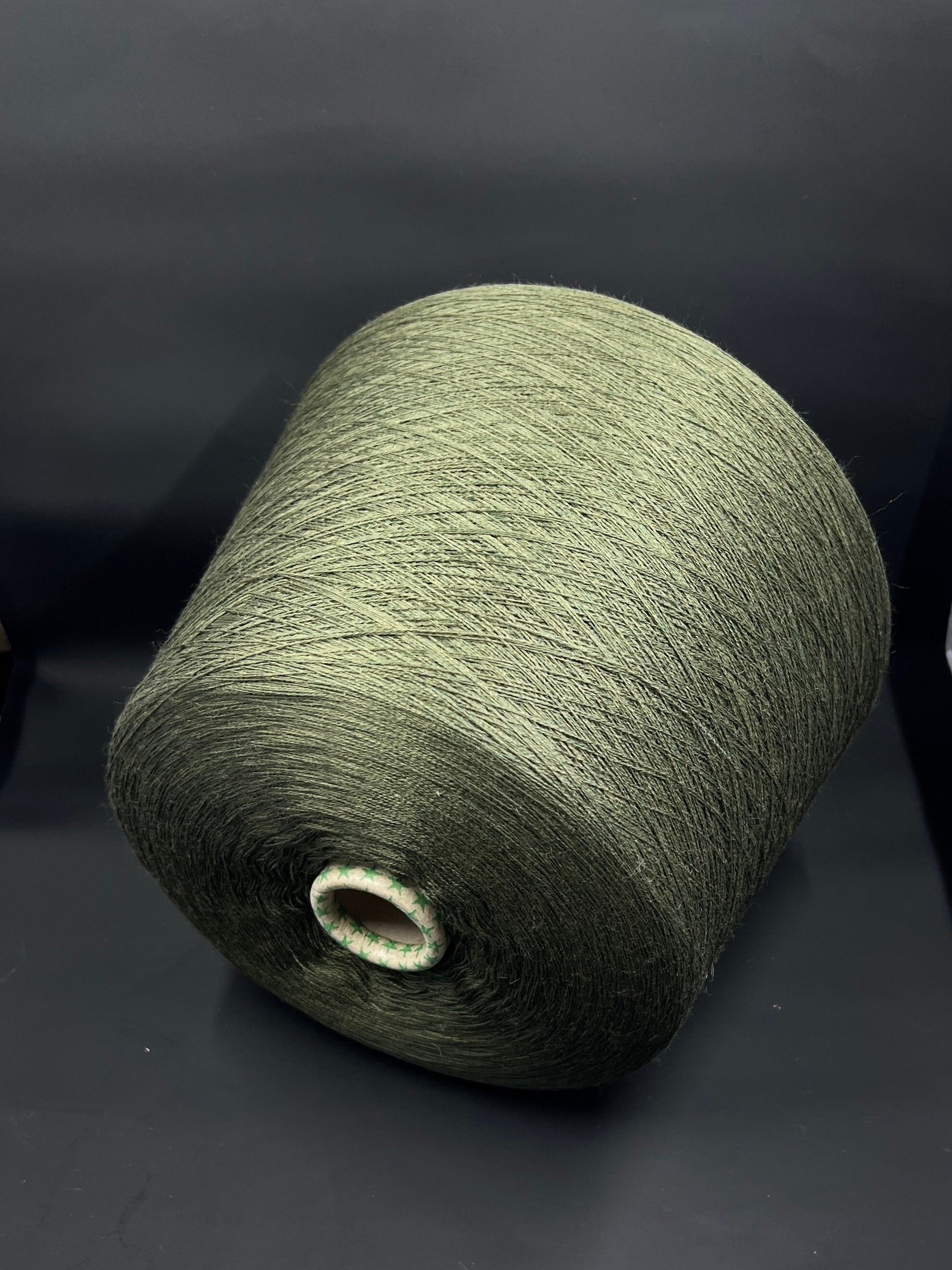 Material: 100% Extra Fine Merino Wool Yarn by Tollegno, HARMONY 4. Fiber Composition: 100% Extrafine Merino Wool yarn. Color: Oliva. Experience the luxurious softness of our 100% Fine Merino Merino Wool Yarn. This yarn showcases the exceptional quality of Extra Fine Merino wool.