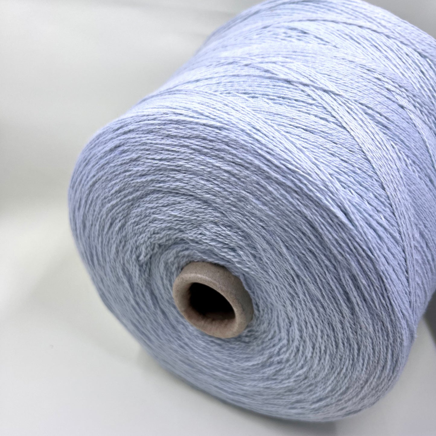 Wool Yarn 30%, Viscosa Yarn 25%, Cashmere Yarn 15%, Poliamide Yarn 30%. Profilo SNC , Color Sky, Yarn on Cone. Italian Lace Yarn. Hand and Machine Knitting. Reference: Nm 2/15. Italian Lace Yarn, Machine knitting, Hand Knitting.