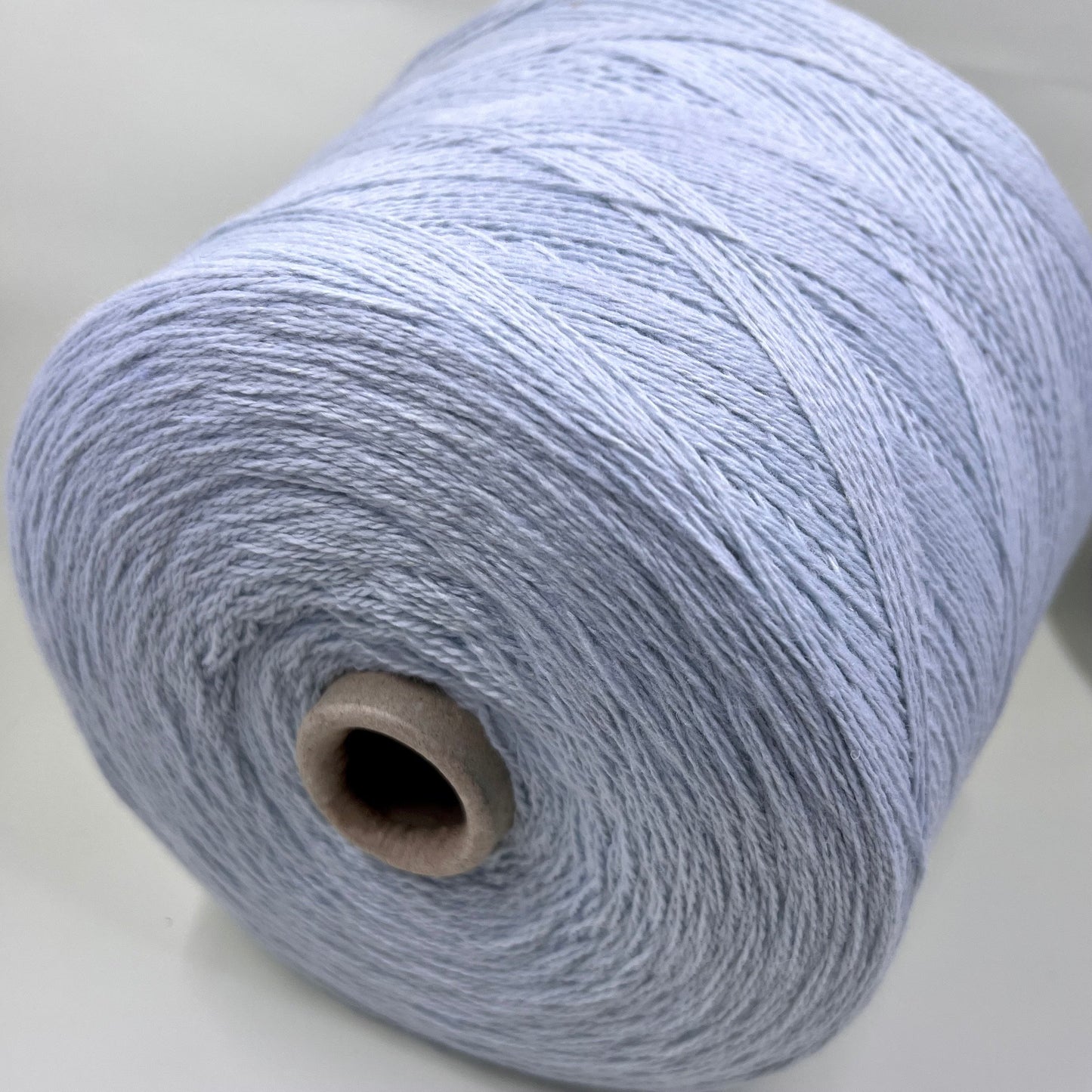 Wool Yarn 30%, Viscosa Yarn 25%, Cashmere Yarn 15%, Poliamide Yarn 30%. Profilo SNC , Color Sky, Yarn on Cone. Italian Lace Yarn. Hand and Machine Knitting. Reference: Nm 2/15. Italian Lace Yarn, Machine knitting, Hand Knitting.