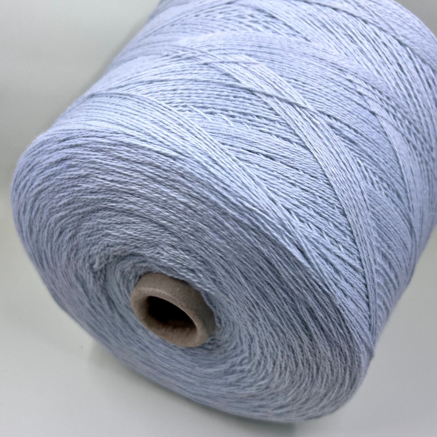 Wool Yarn 30%, Viscosa Yarn 25%, Cashmere Yarn 15%, Poliamide Yarn 30%. Profilo SNC , Color Sky, Yarn on Cone. Italian Lace Yarn. Hand and Machine Knitting. Reference: Nm 2/15. Italian Lace Yarn, Machine knitting, Hand Knitting.