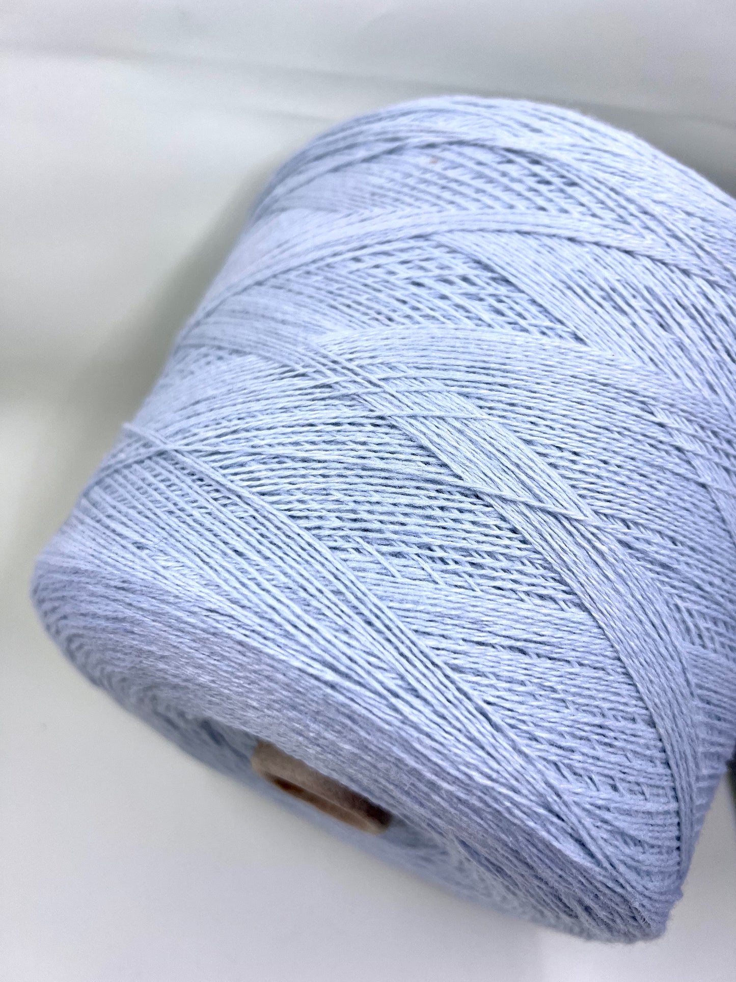 Wool Yarn 30%, Viscosa Yarn 25%, Cashmere Yarn 15%, Poliamide Yarn 30%. Profilo SNC , Color Sky, Yarn on Cone. Italian Lace Yarn. Hand and Machine Knitting. Reference: Nm 2/15. Italian Lace Yarn, Machine knitting, Hand Knitting.