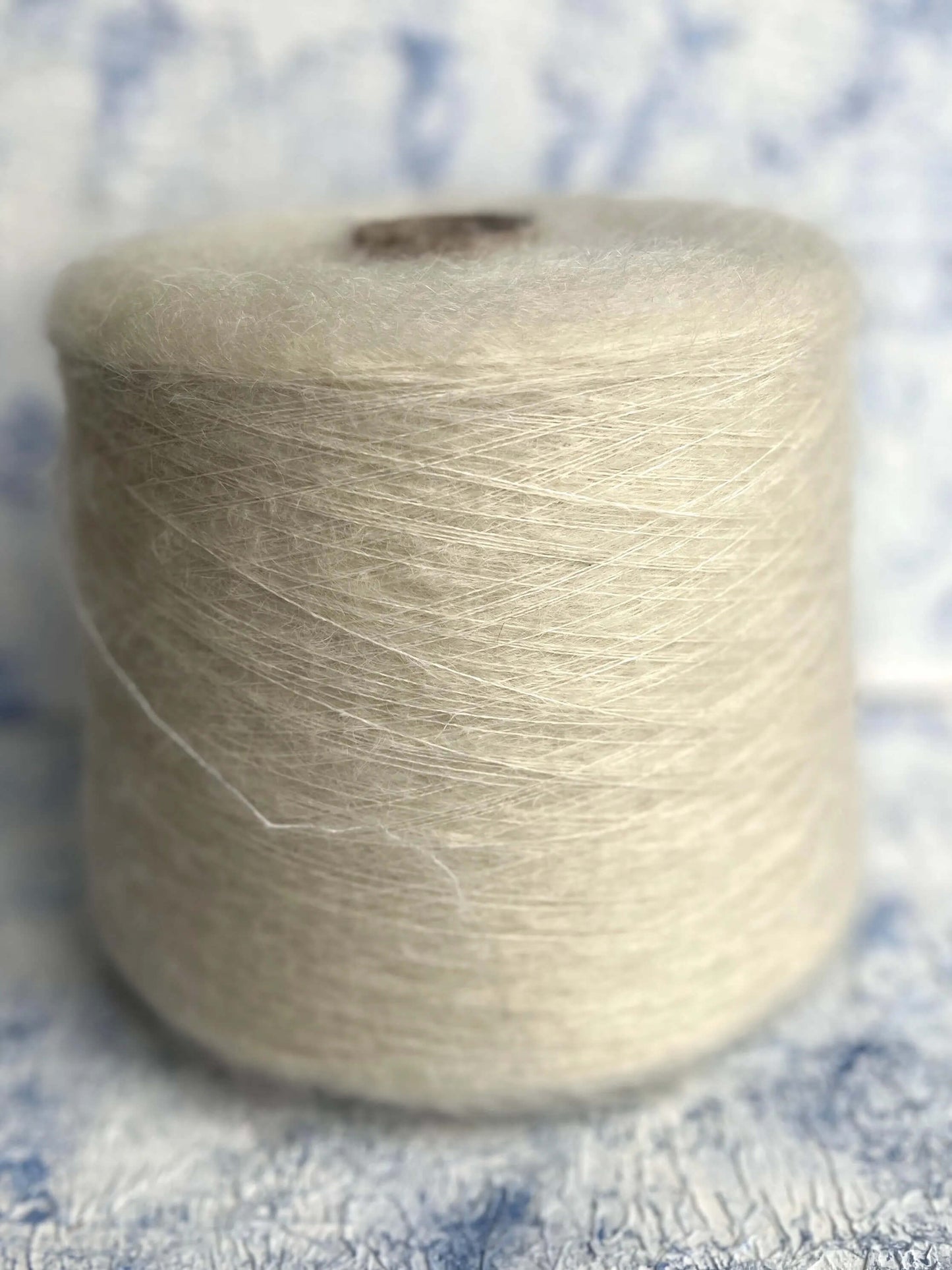 SuperKidMohair Yarn 67%, PA Yarn 30%, Merino Yarn 3%. Yarn on Cone, Color White. Per 100 gr