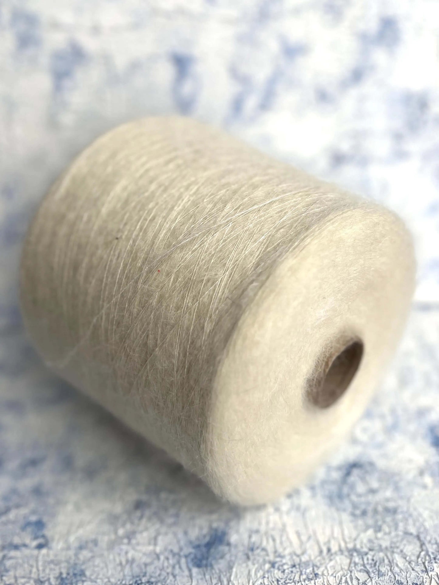 SuperKidMohair Yarn 67%, PA Yarn 30%, Merino Yarn 3%. Yarn on Cone, Color White. Per 100 gr