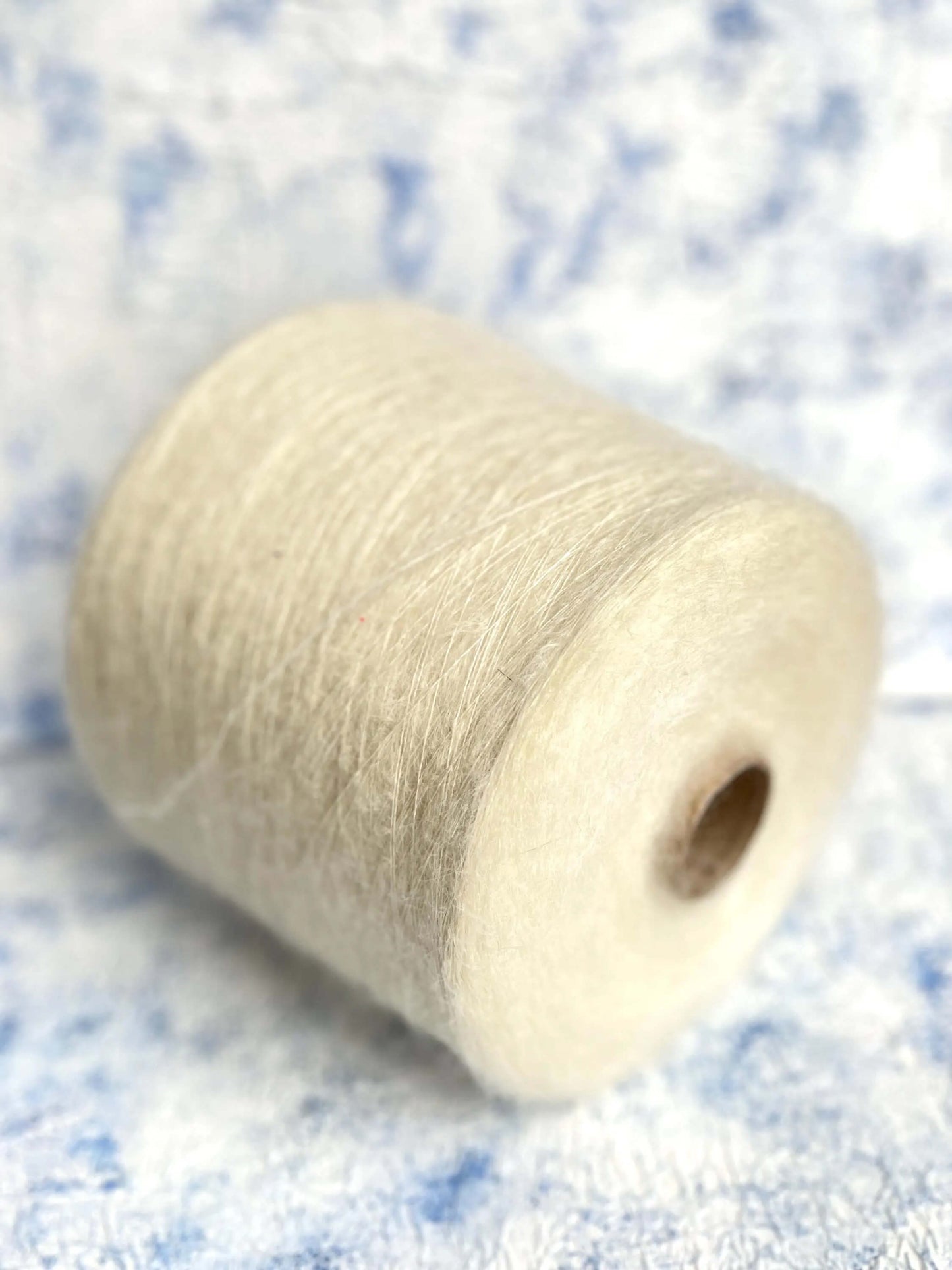 SuperKidMohair Yarn 67%, PA Yarn 30%, Merino Yarn 3%. Yarn on Cone, Color White. Per 100 gr