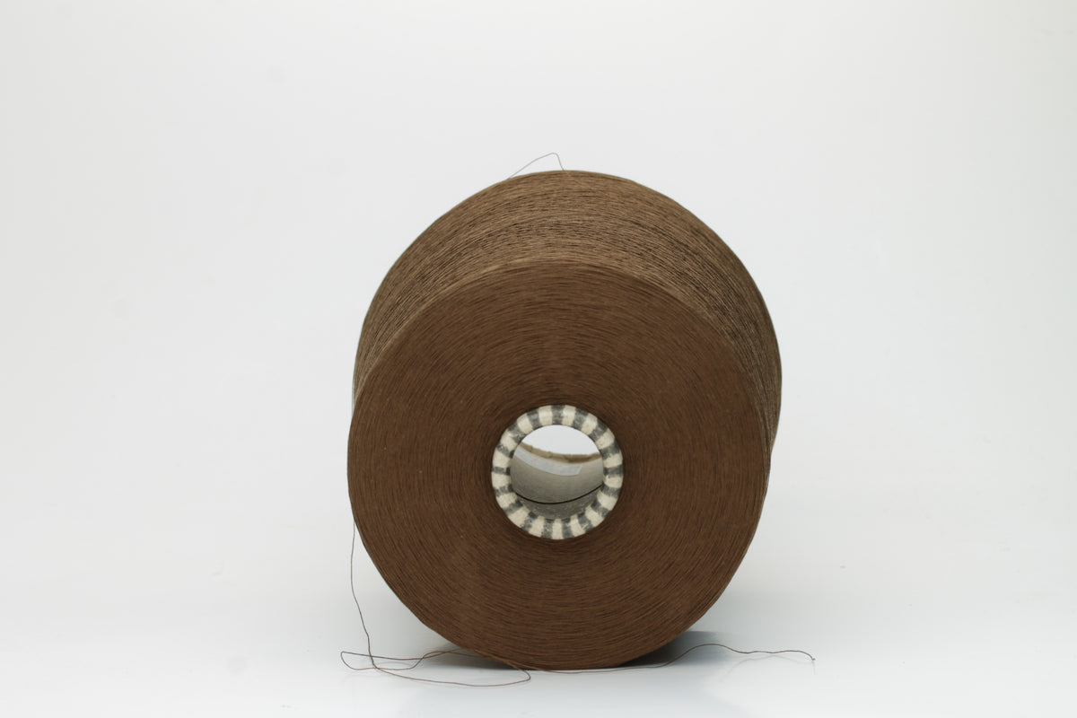 Smooth, tightly twisted two-ply cotton yarn in a rich, warm chestnut brown. Displays a subtle sheen and fine, even thread structure.