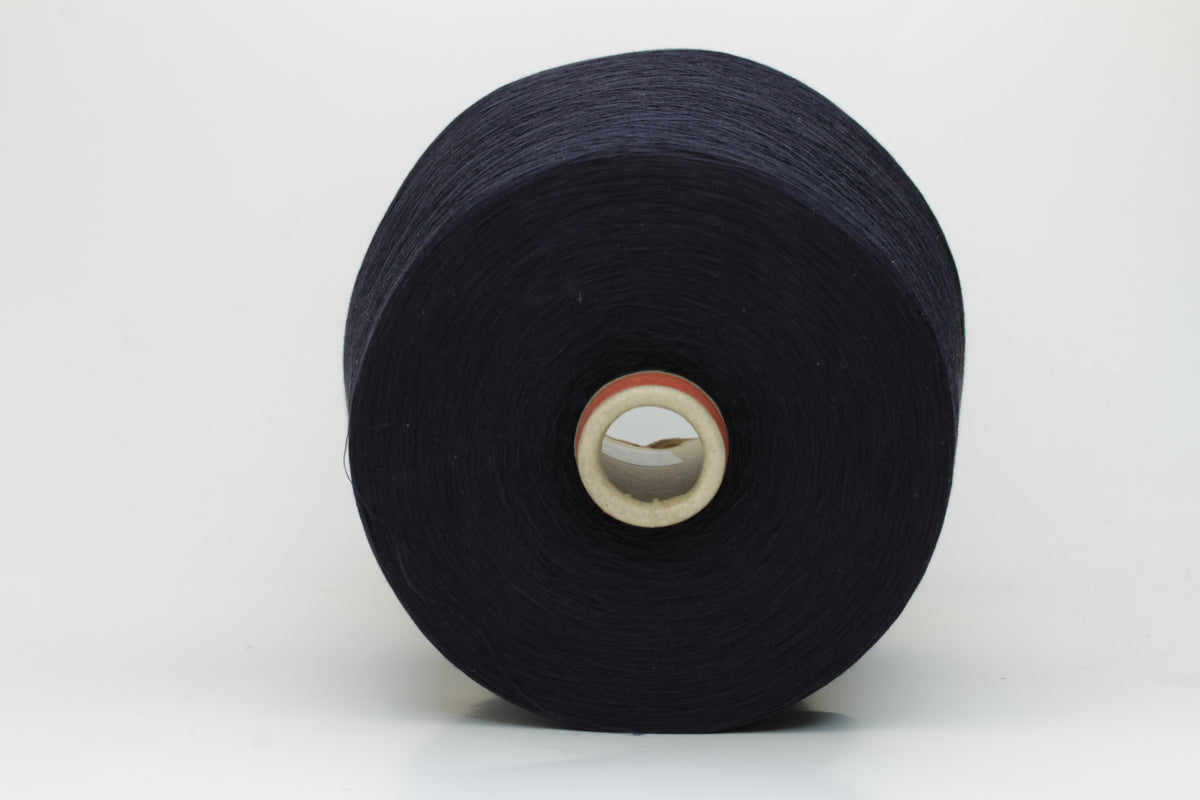 A skein of finely spun, smooth 100% cotton yarn in a deep Midnight Navy, showing a subtle sheen and even, uniform twist.
