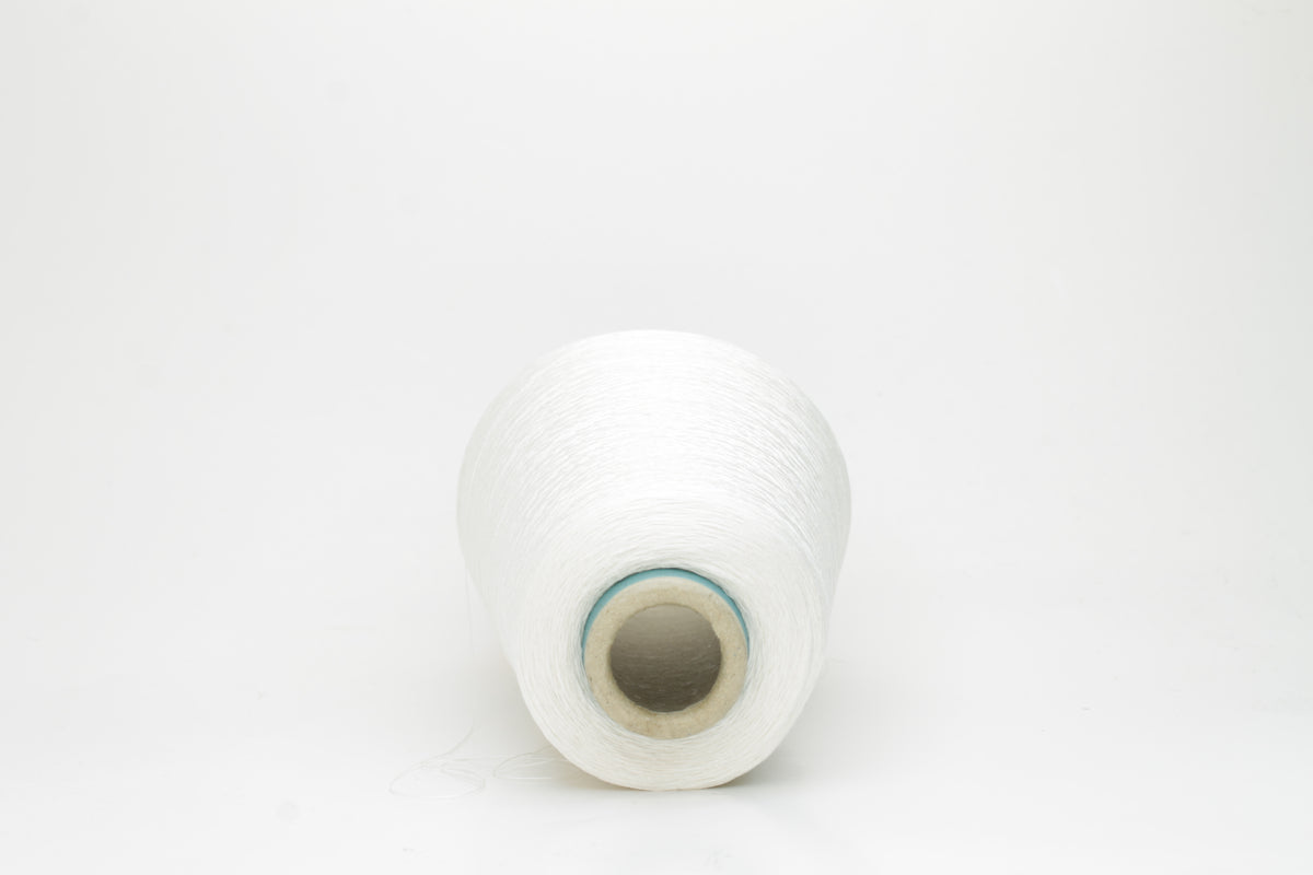 Close-up of a skein of lustrous, pure white silk yarn, tightly plied with a smooth, radiant finish, reflecting light softly.
