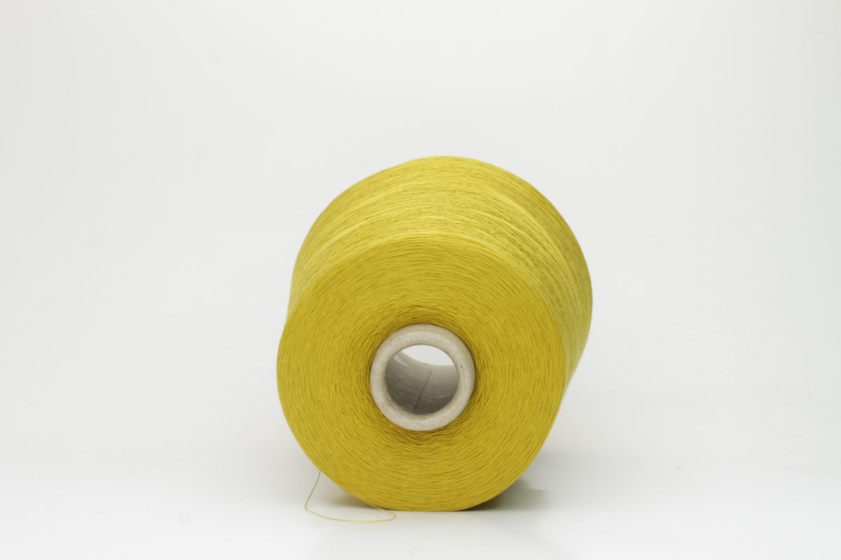 Close-up of tightly plied 100% cotton yarn in a vivid chartreuse yellow, displaying a subtle sheen and consistent twist.