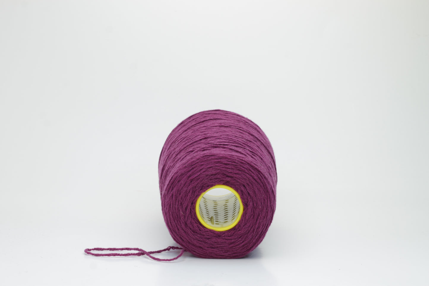 Close-up of soft, lustrous pure cashmere yarn, gently twisted, revealing a rich, deep anemone purple with a subtle, velvety halo.