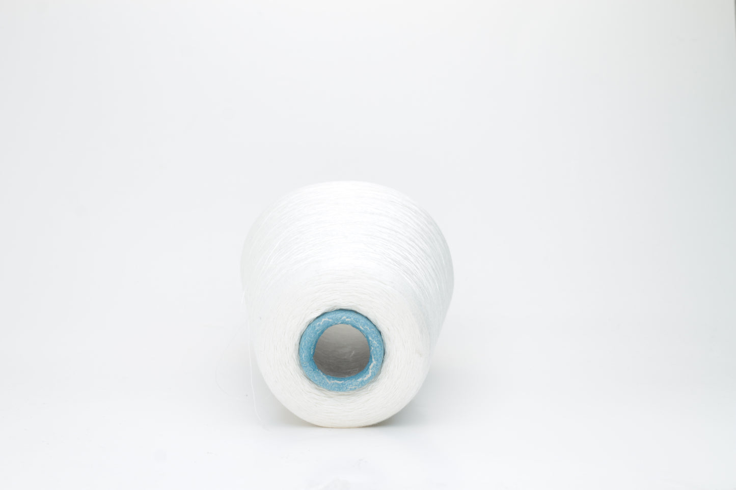 Fine, pure white silk yarn, tightly twisted with a subtle, radiant sheen. Smooth texture, uniform ply, elegant thread structure for delicate projects.