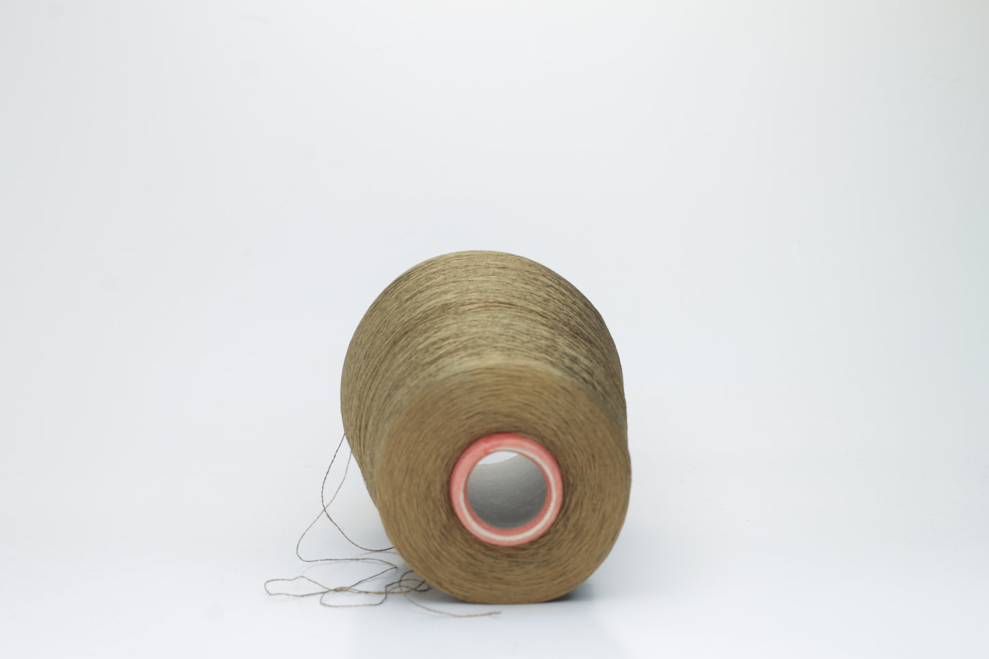 Close-up of a spool of finely twisted, single-ply Organzino silk yarn in a deep, lustrous bronze hue, catching light with a subtle, elegant sheen.