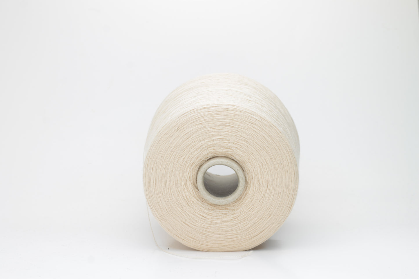 Close-up of luxurious Beige Merino wool yarn, two-ply twist with a soft, subtle sheen, and fine, consistent thread structure.