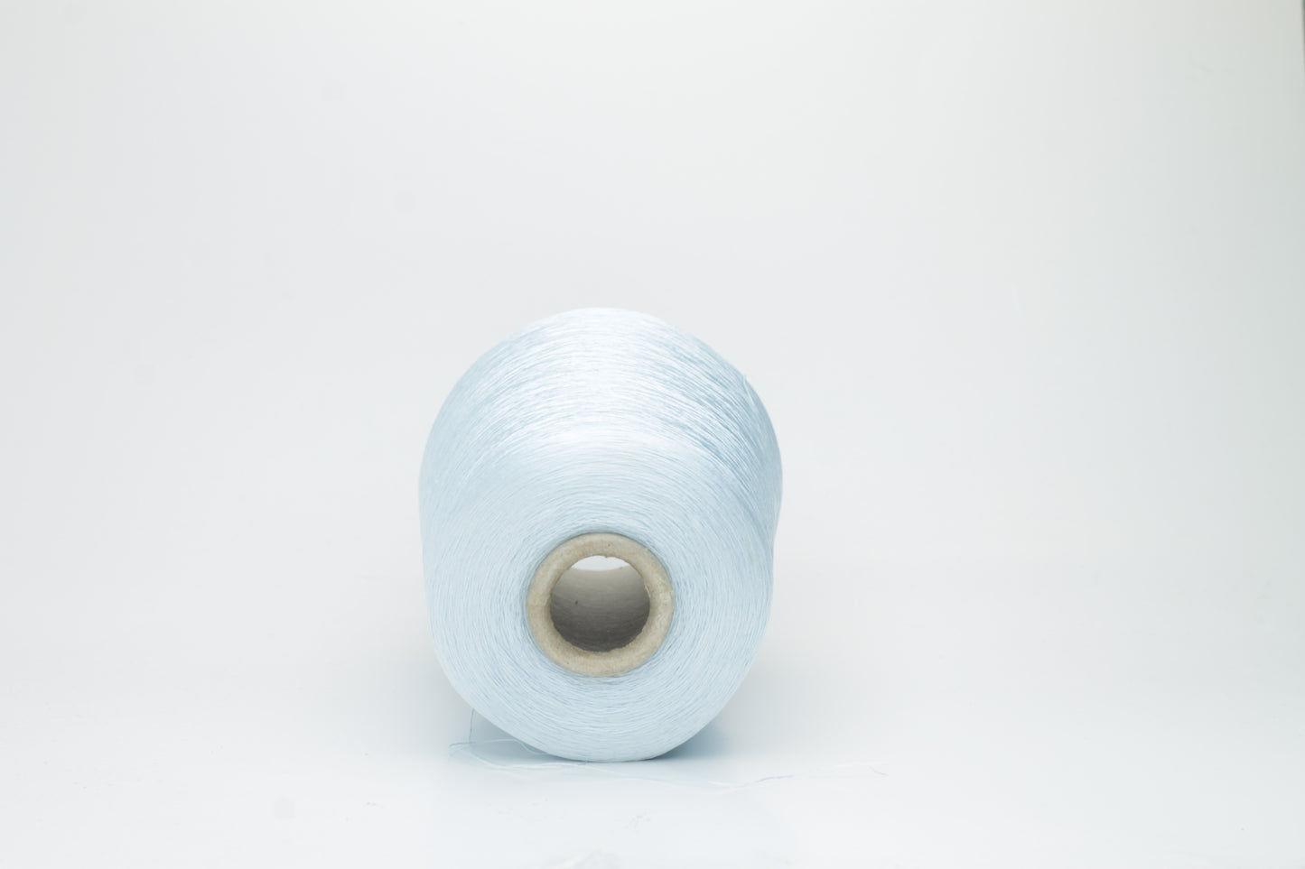Fine, smooth, two-ply silk yarn in a vibrant sky blue. It exhibits a subtle sheen and a uniform, tight twist, reflecting light beautifully.