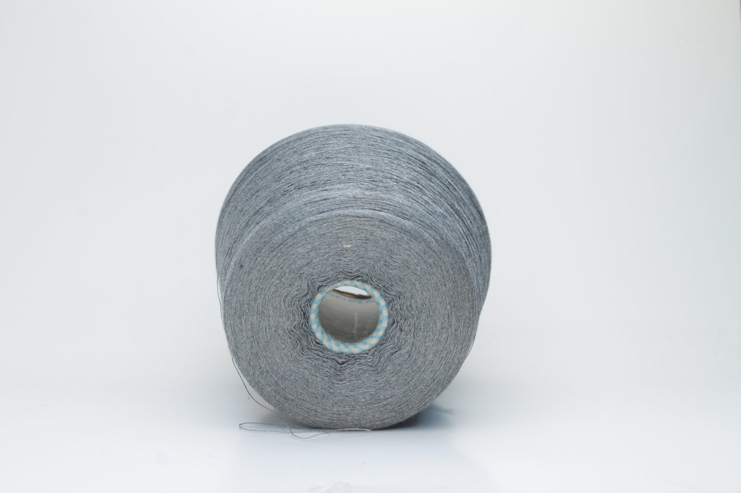 Close-up of a meticulously twisted two-ply 100% silk yarn, revealing a subtle, sophisticated medium gray hue with a natural, elegant sheen.