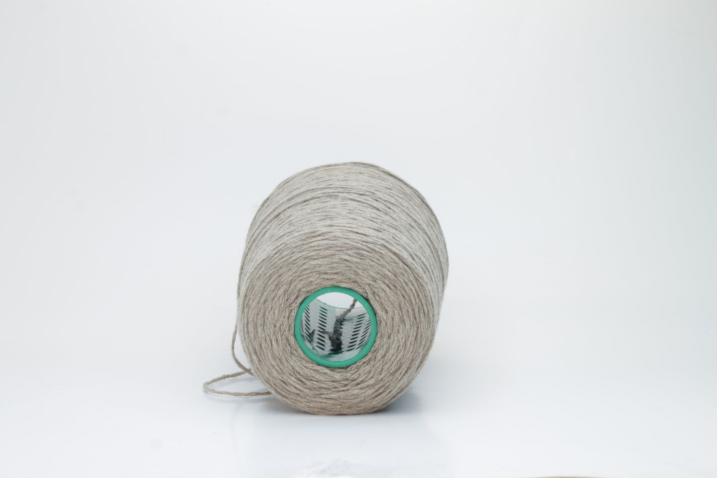 A finely spun, single-ply cashmere yarn in a rich, warm squirrel-brown, exhibiting a delicate halo of soft fibers and a subtle, natural sheen.