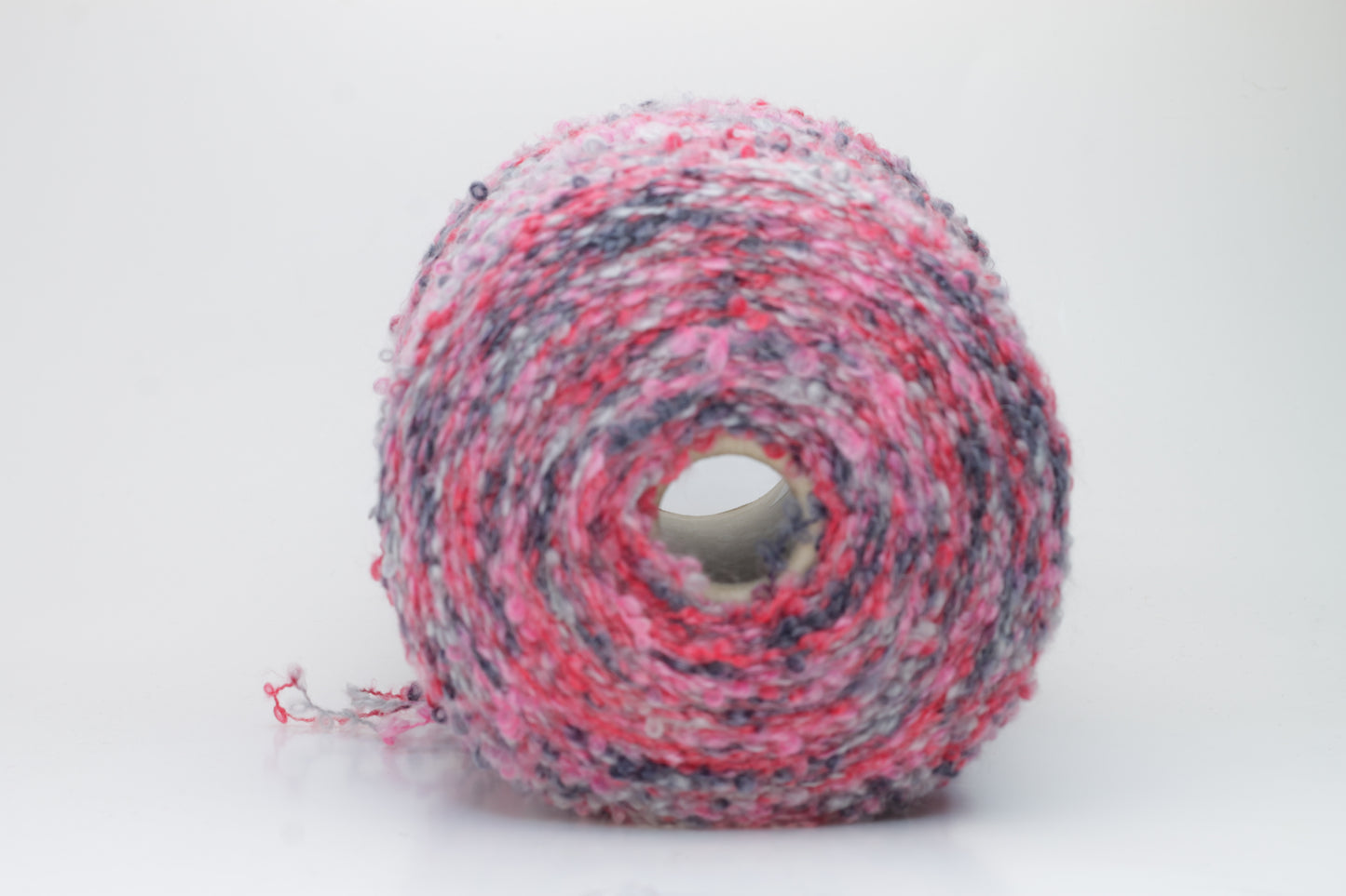 Close-up shot of multicolored SuperKidMohair yarn, showcasing its fluffy texture, slight sheen, and tight ply twist – a rich blend ready for knitting or weaving.