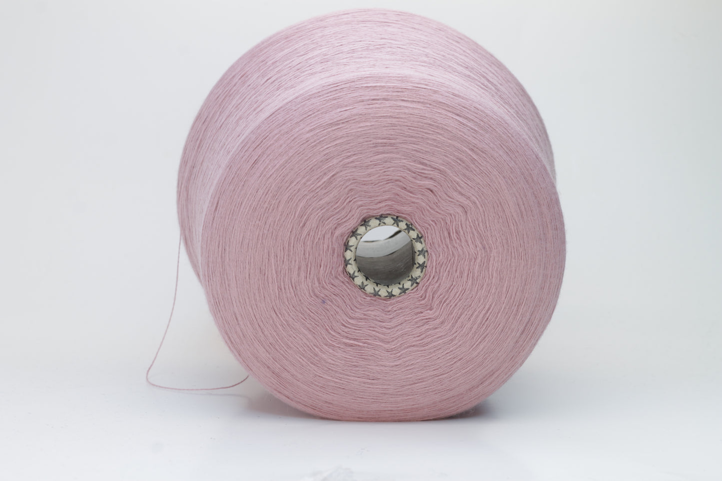 Close-up studio shot showcasing the 'Harmony 2' merino yarn in a rich 'Rosa' hue. The yarn exhibits a tight, twisted ply with an even thread structure, creating subtle sheen and a fluffy texture.