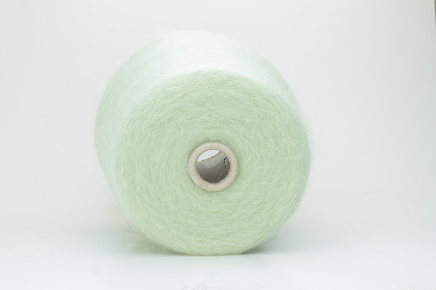 Close-up view of Light Green SuperKidMohair yarn showing a dense, fluffy pile structure and subtle sheen. The yarn has a uniform ply twist with a rich color depth.