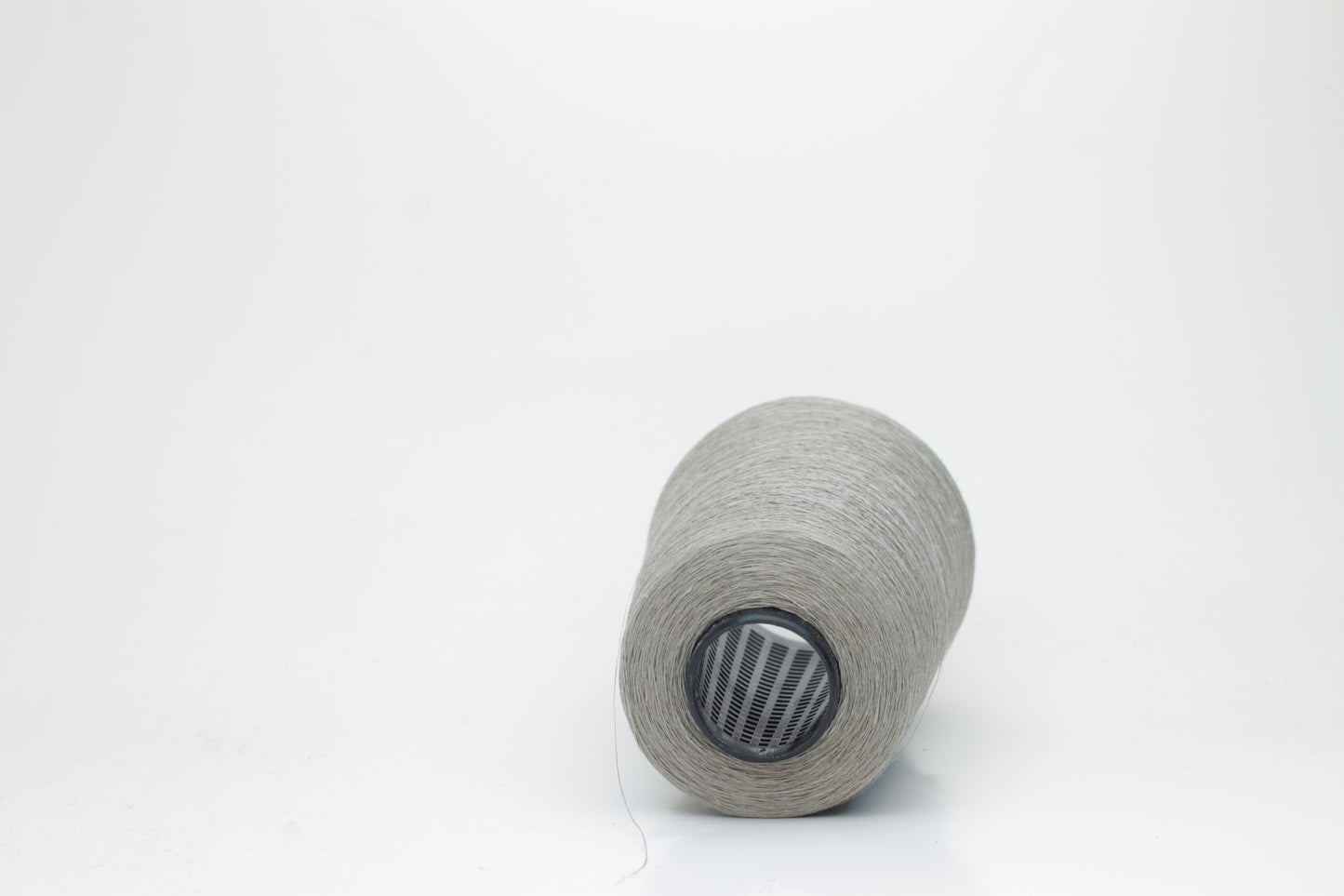 Fine, single-ply linen yarn in a rich Silver Gray. Reveals a crisp texture and subtle natural sheen, typical of pure linen fiber.