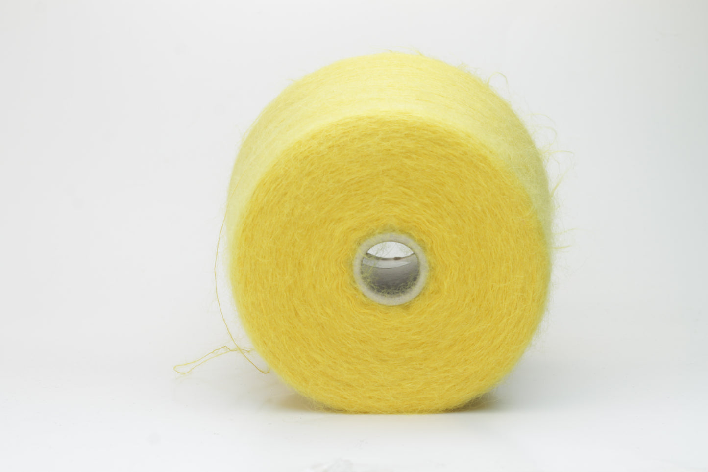 Close-up view of vibrant yellow SuperKidMohair yarn in a loose, fluffy ply twist. The yarn exhibits significant sheen and fluffiness, with distinct individual fibers visible.