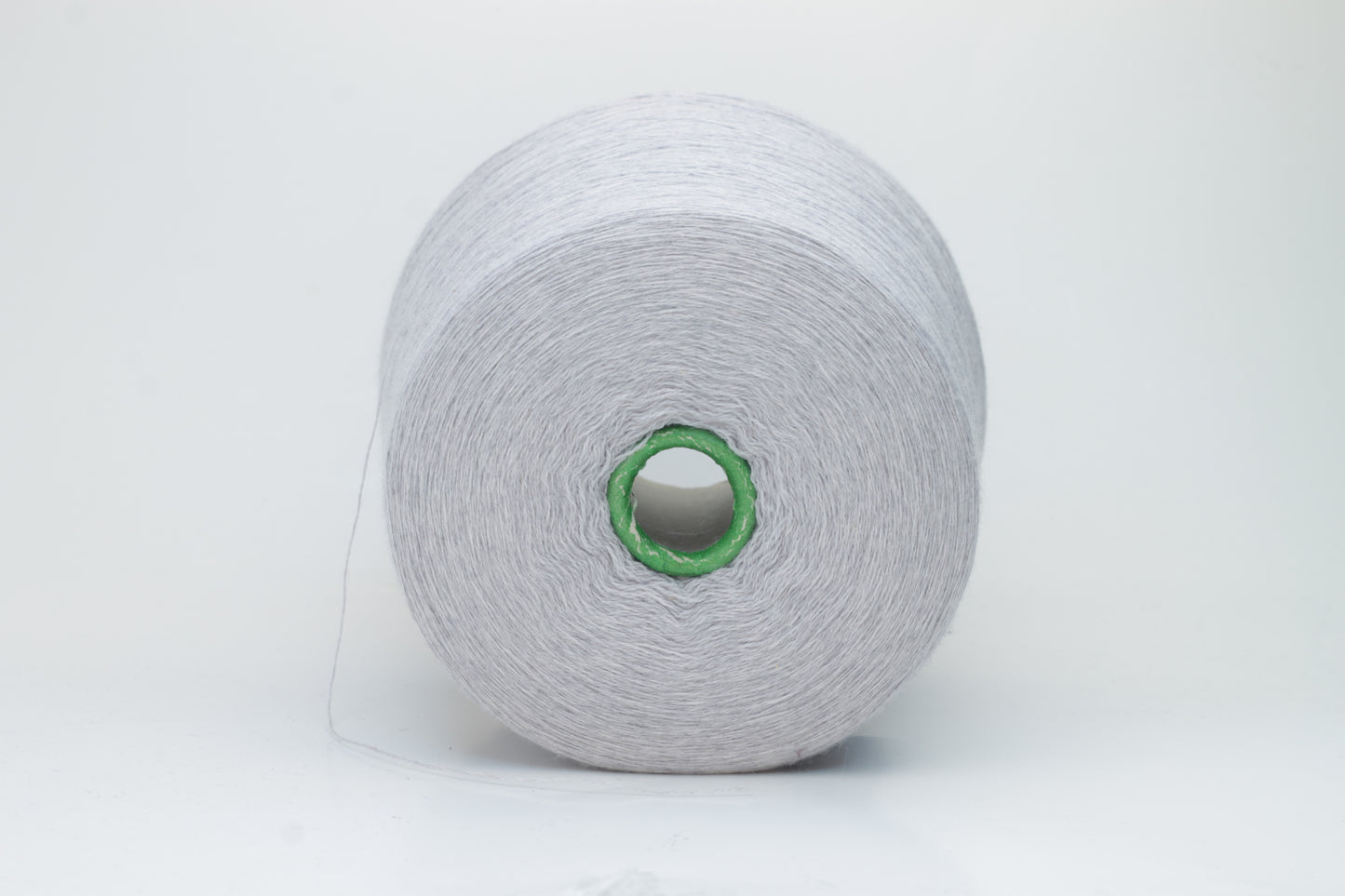 Close-up of a luxurious light blue merino wool yarn skein, showcasing its fine ply twist and subtle sheen, emphasizing the soft fluffiness and vibrant color depth.