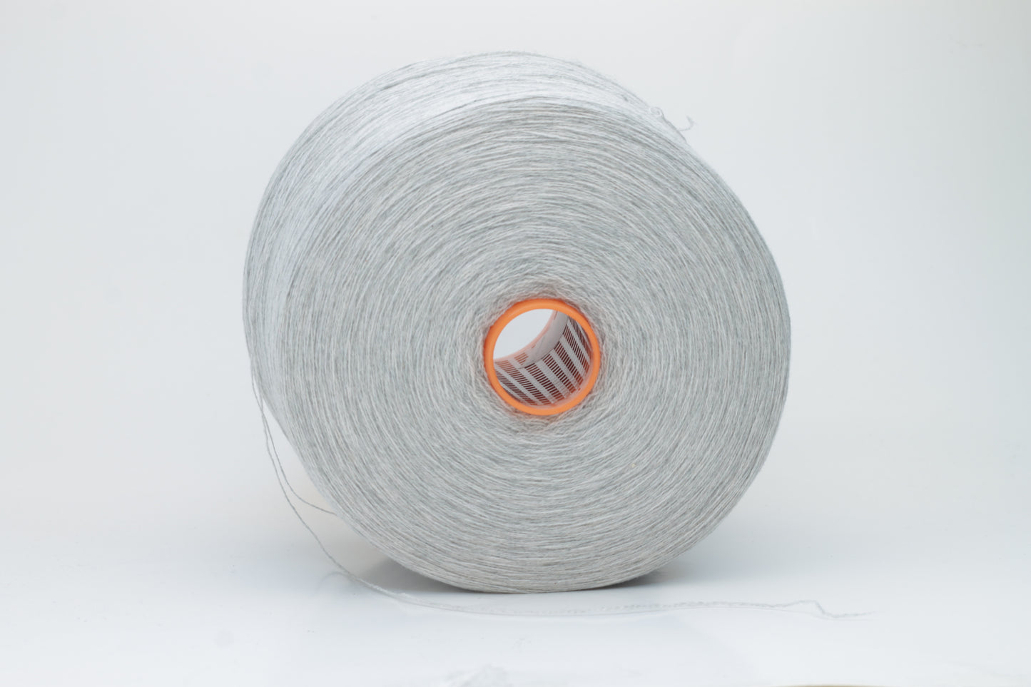 Close-up of a skein of luxurious, soft gray 100% cashmere yarn, featuring a gentle halo and a subtle, refined sheen. The two-ply structure is visible, showing even twist and consistent depth of the elegant cool gray color.