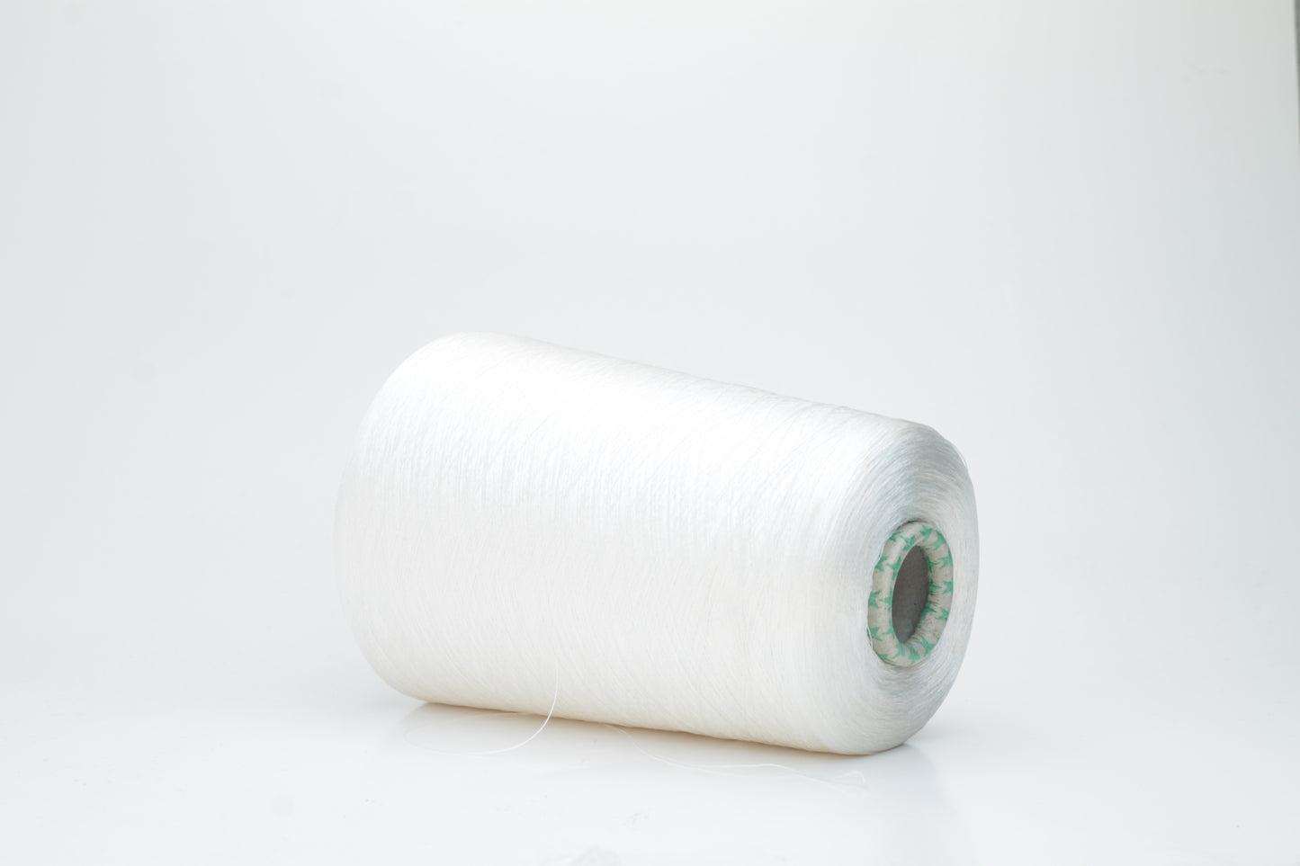 Close-up of brilliant white 100% silk yarn, single-ply strand with a smooth, highly lustrous surface, softly draped. Shimmering.