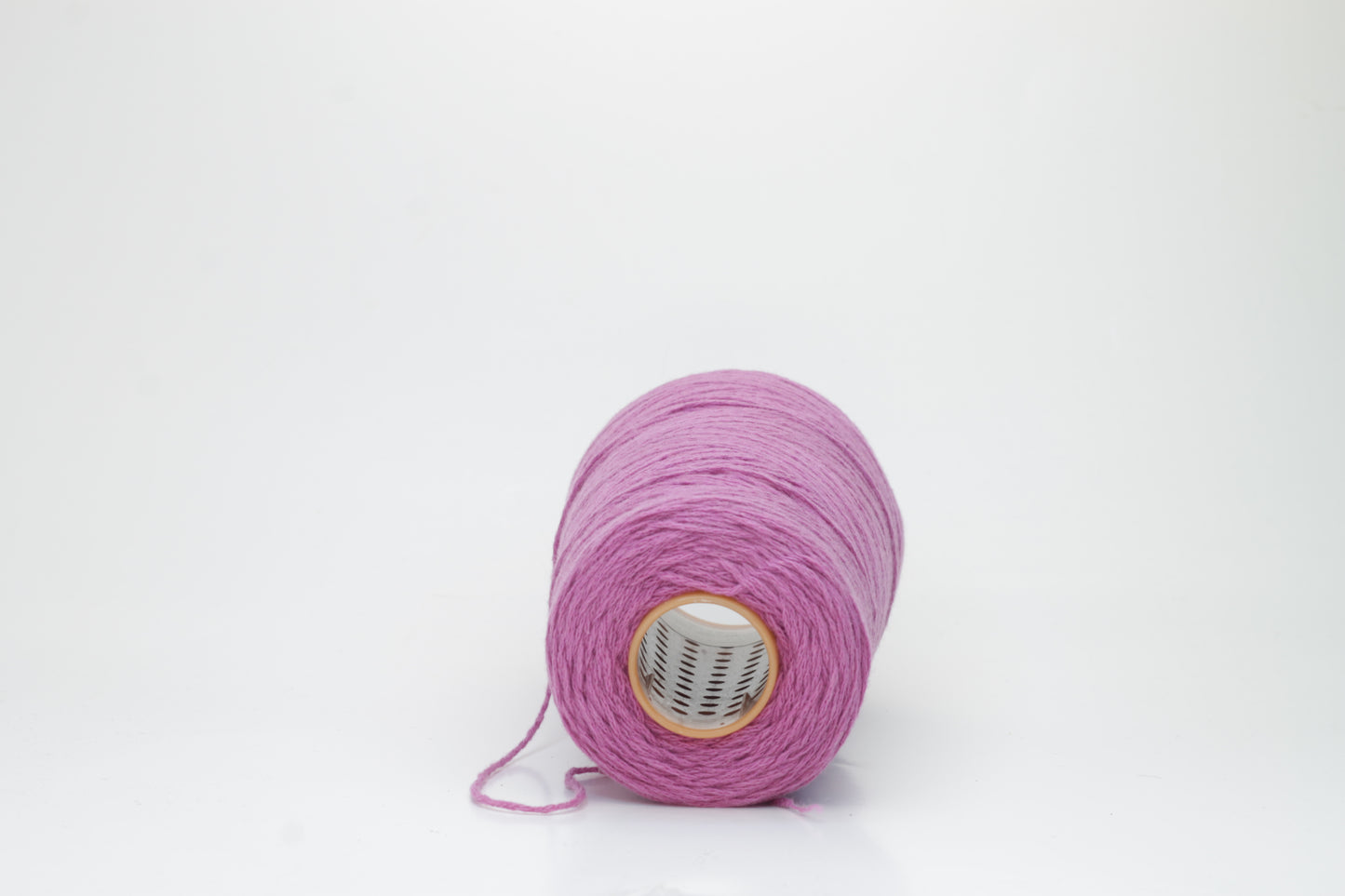 A beautifully wound cone of fine, single-ply cashmere yarn in a soft wisteria purple hue, displaying a delicate halo of fluff and subtle sheen.