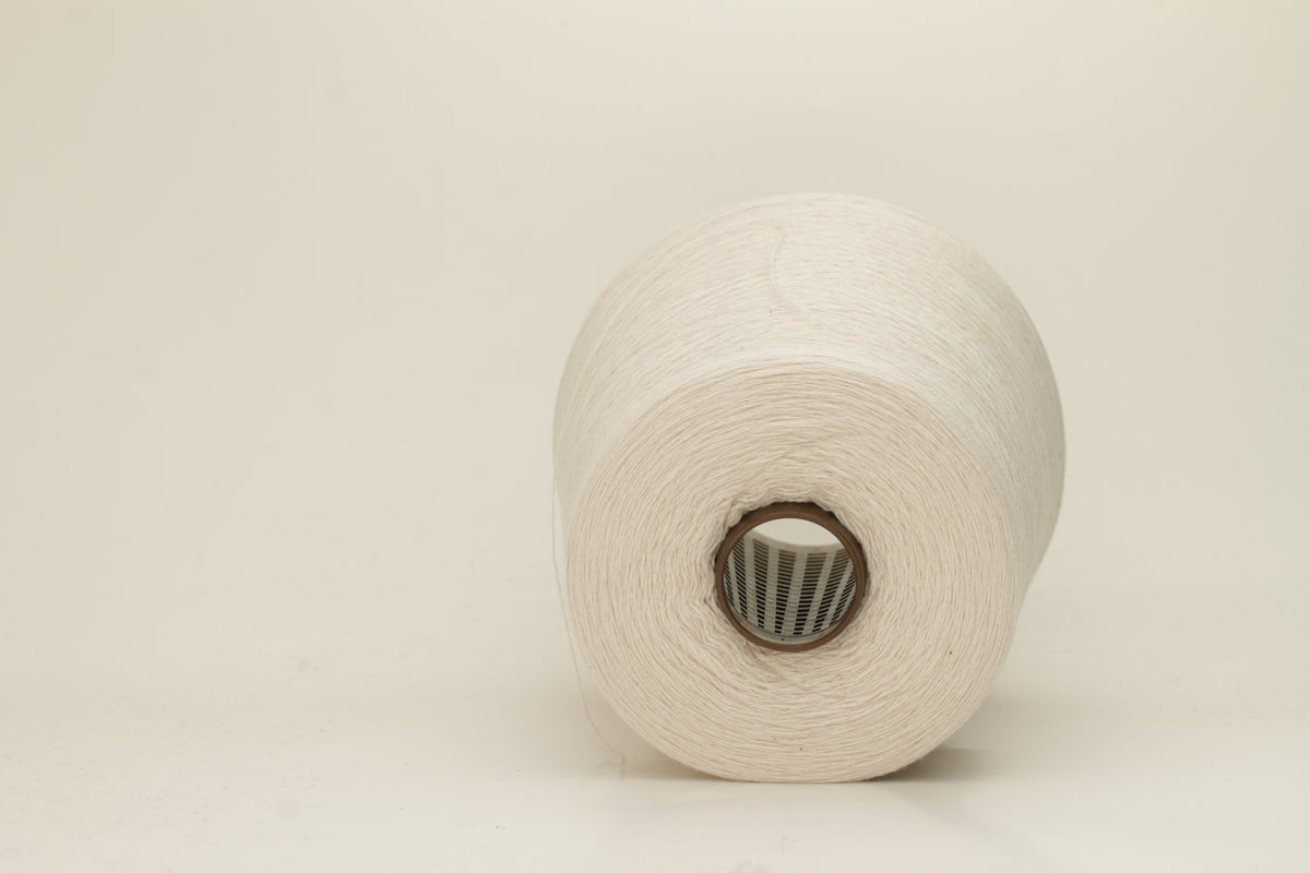 Rich, White 2-ply yarn with a fine, smooth twist; exhibits a subtle sheen and incredibly soft, uniform texture.