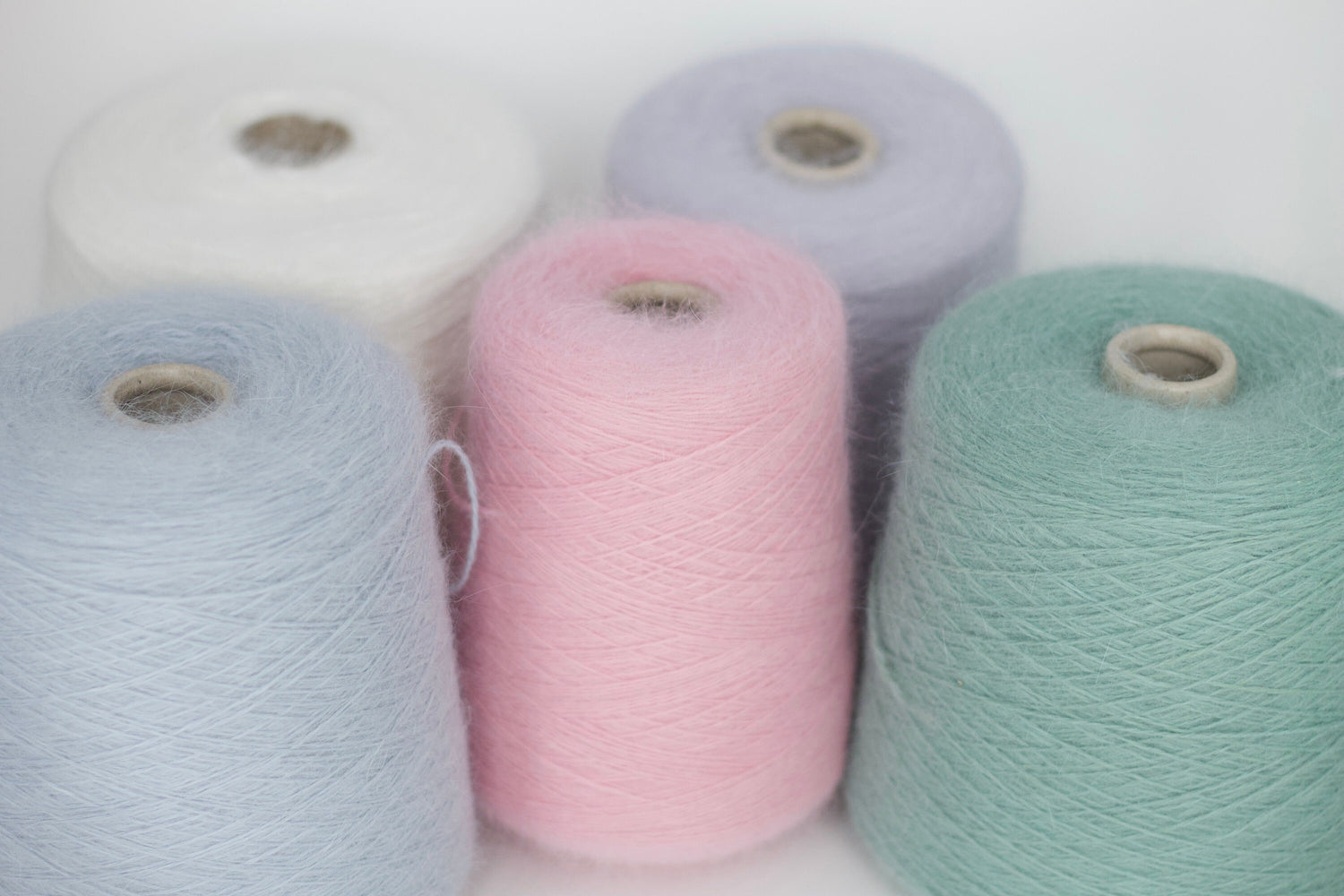 Delicate and fluffy Angora yarn in various shades, perfect for warm and soft knitting projects like sweaters and scarves