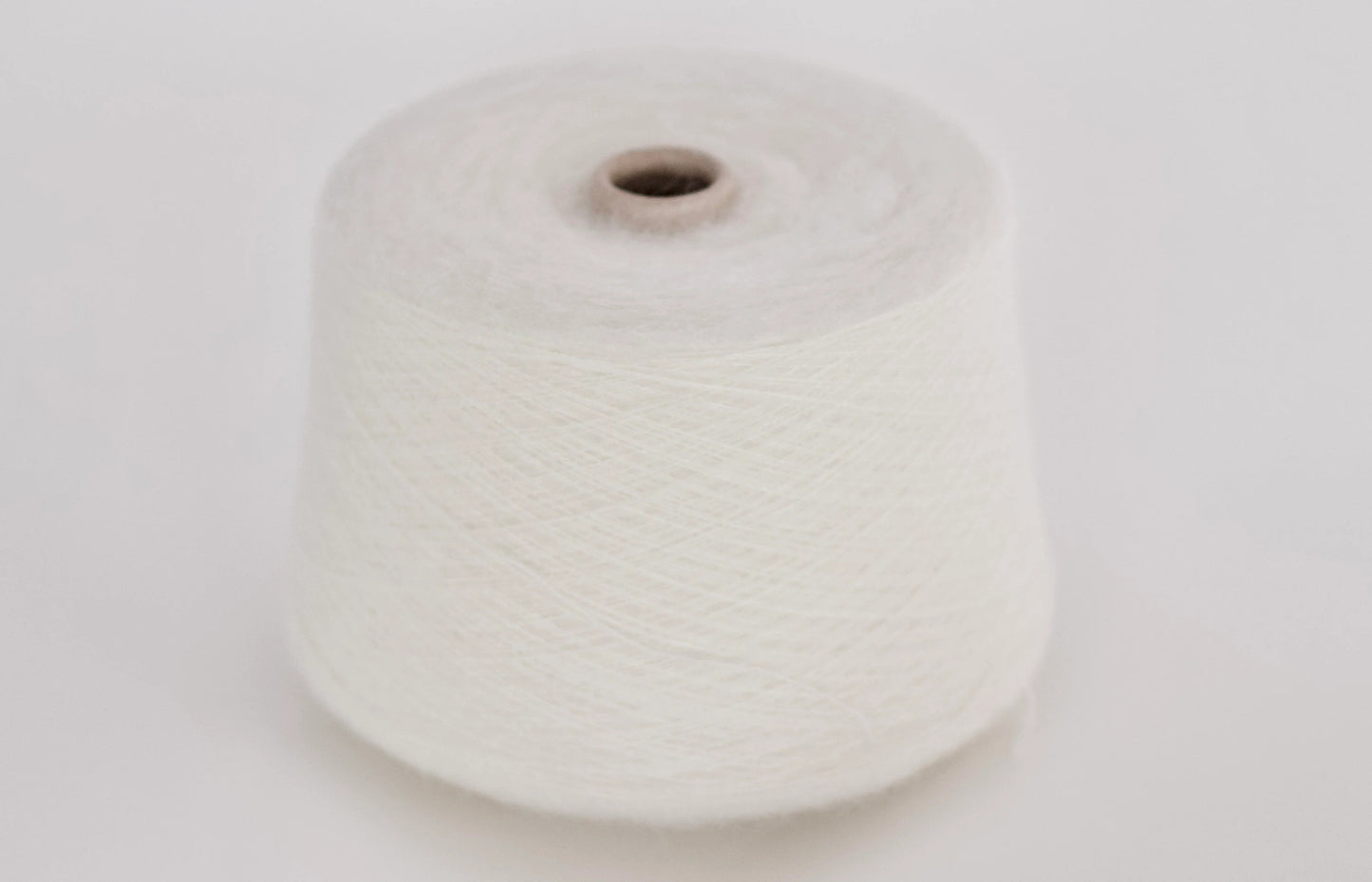 Super Kid Mohair Yarn & Poliamide Yarn. Fibre: 70% Super kid mohair Yarn, 30% Poliamide Yarn. Reference: PROFILO S.N.C. Color: white. This is a luxurious yarn, very soft and fluffy yarn with a wonderful composition yarn of 70% Super Kid mohair yarn and 30% PA yarn. Can be used for knitting (both machine and hand).