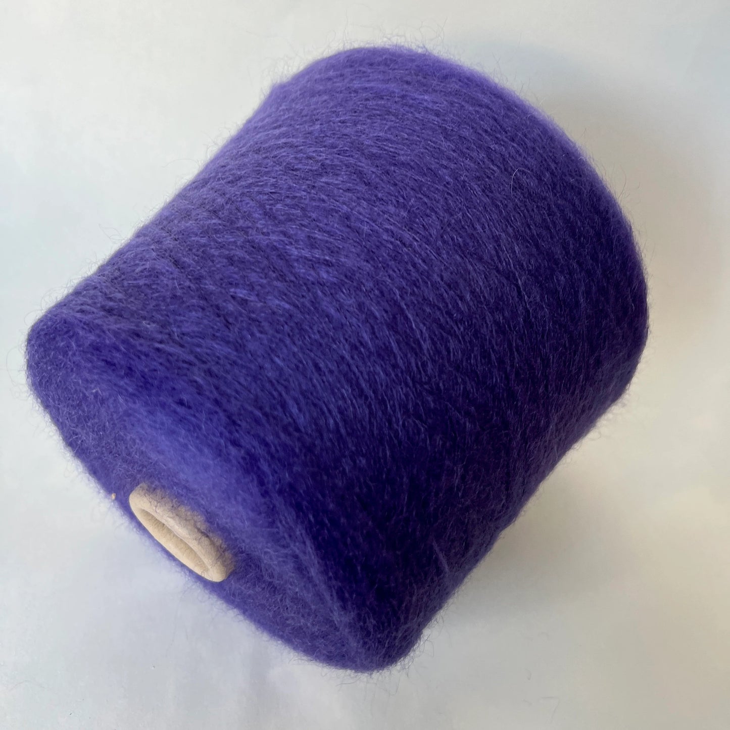 Reference: Super Kid mohair Yarn & Poliamide Yarn. PROFILO Yarn, Art: GLOPIA. Fibre: 70% Super kid mohair Yarn, 30% PA Yarn. Color: Violetto. This is a luxurious yarn, very soft and fluffy yarn with a wonderful composition of 70% Super Kid mohair yarn and 30% PA Yarn. Yarn on Cone. Yarn for knitting.