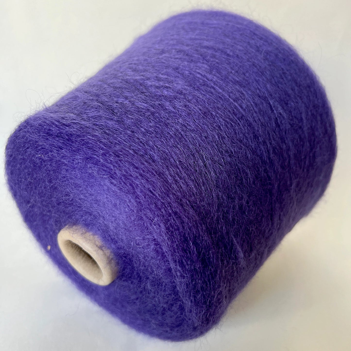 Reference: Super Kid mohair Yarn & Poliamide Yarn. PROFILO Yarn, Art: GLOPIA. Fibre: 70% Super kid mohair Yarn, 30% PA Yarn. Color: Violetto. This is a luxurious yarn, very soft and fluffy yarn with a wonderful composition of 70% Super Kid mohair yarn and 30% PA Yarn. Yarn on Cone. Yarn for knitting.