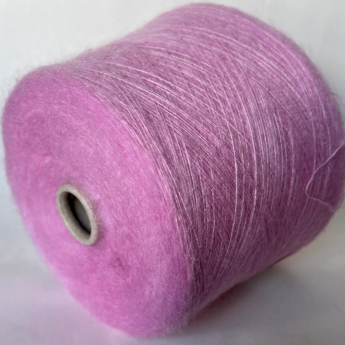 Super Kid Mohair Yarn & Poliamide Yarn. Yarn on Cone. Art: GLOPIA. Fibre: 70% Super kid mohair Yarn & 30% Poliamide Yarn. Color: Rosa. This is a luxurious yarn, very soft and fluffy yarn with a wonderful composition yarn of 70% Super Kid mohair yarn and 30% Poliamide yarn. 