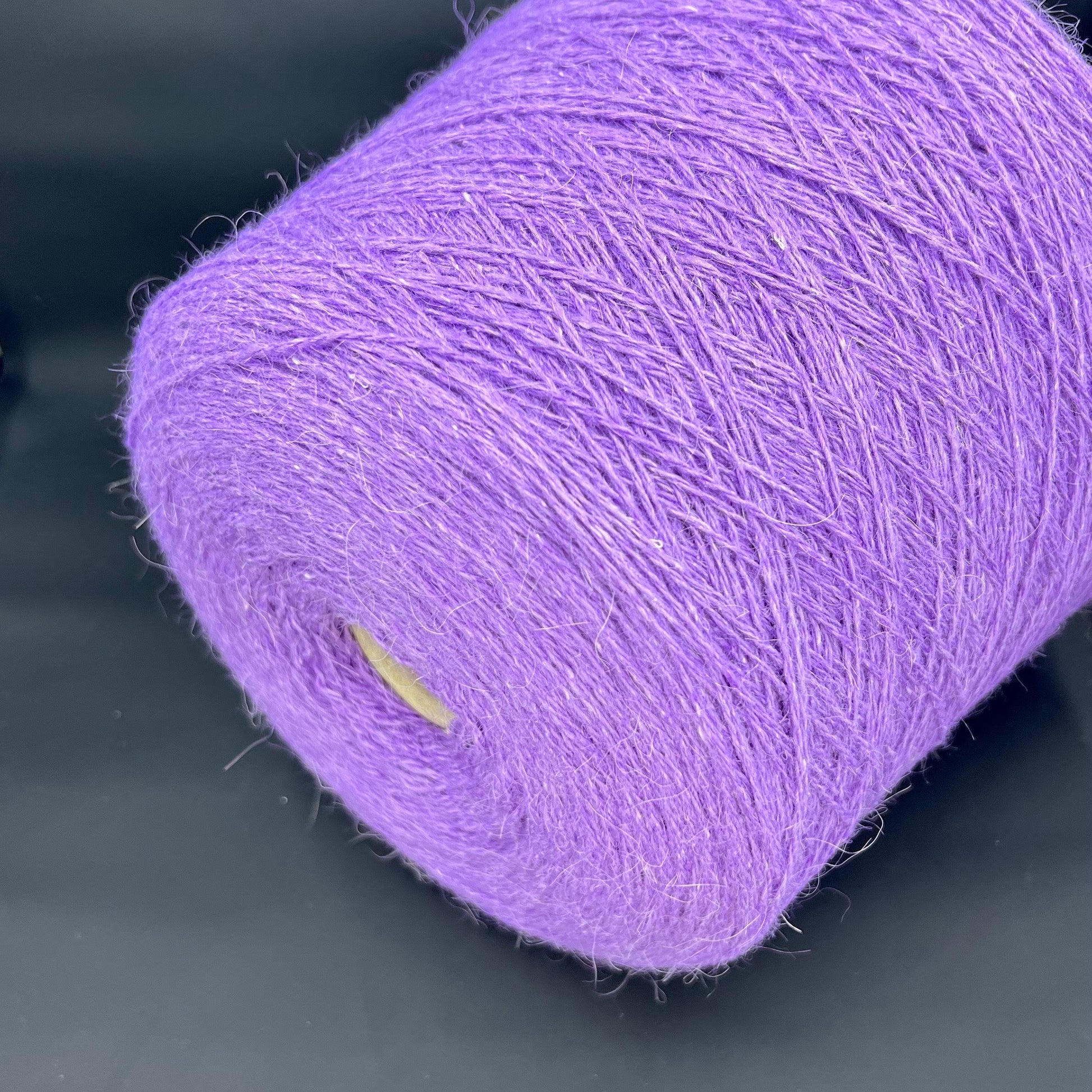 PRPFILO filati art. GINEVRA. Fiber: 20% Angora yarn, 10% Silk yarn, 30% Alpaca yarn, 40% Merino yarn. Colour: Violetta. Yarn in Cone can be purchased at our yarn store. If you need to unwind the purchased yarn into several cones, write to us.