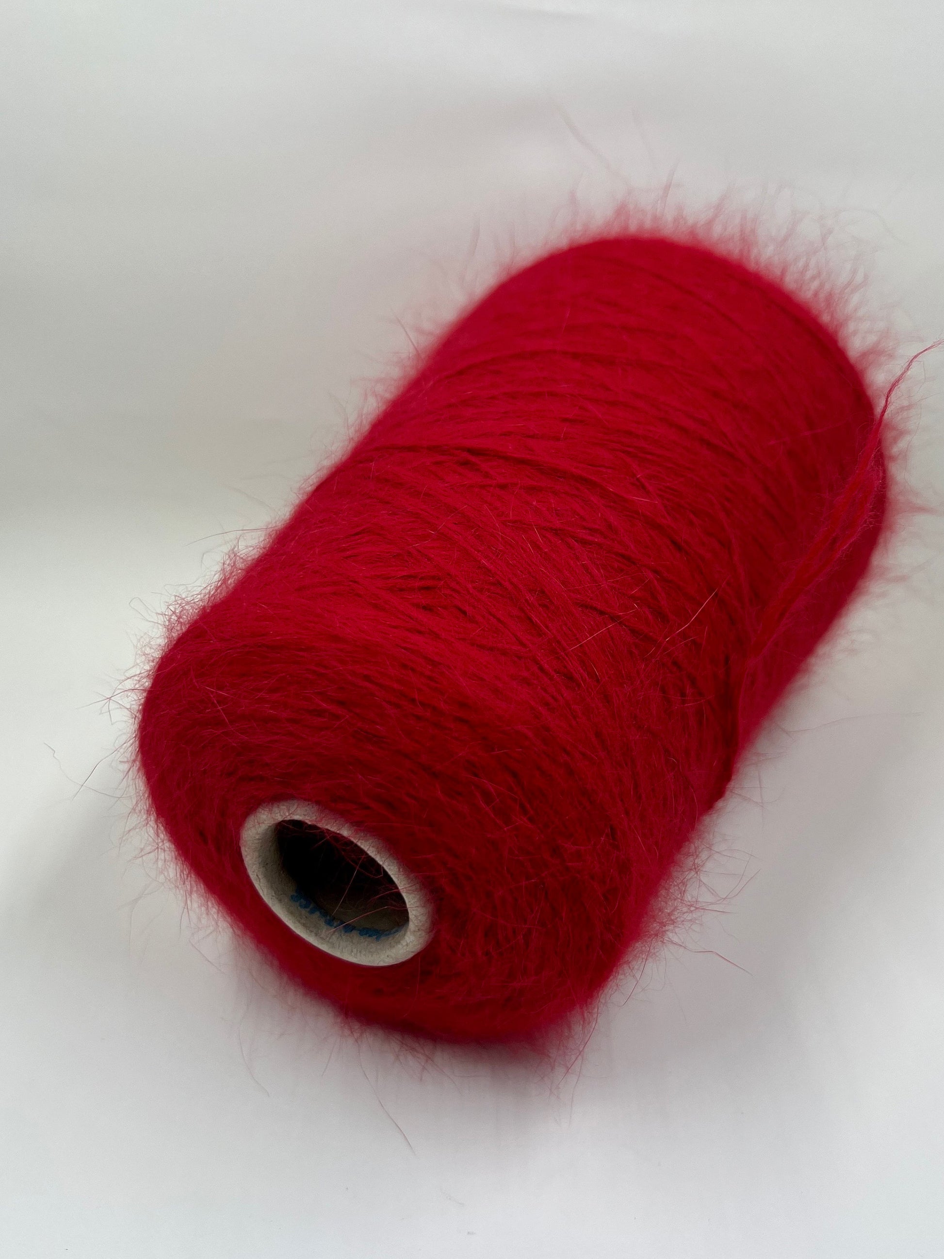 Angora blend Yarn by Profilo. Angora Yarn for Hand & Machine Knitting. Yarn on Cone. Fiber: 80% Angora Yarn & 20% Poliamide. Yarn Colour: Red. Reference: Profilo, Nm 2/10 This is a very soft pure Angora blend yarn by Profilo.