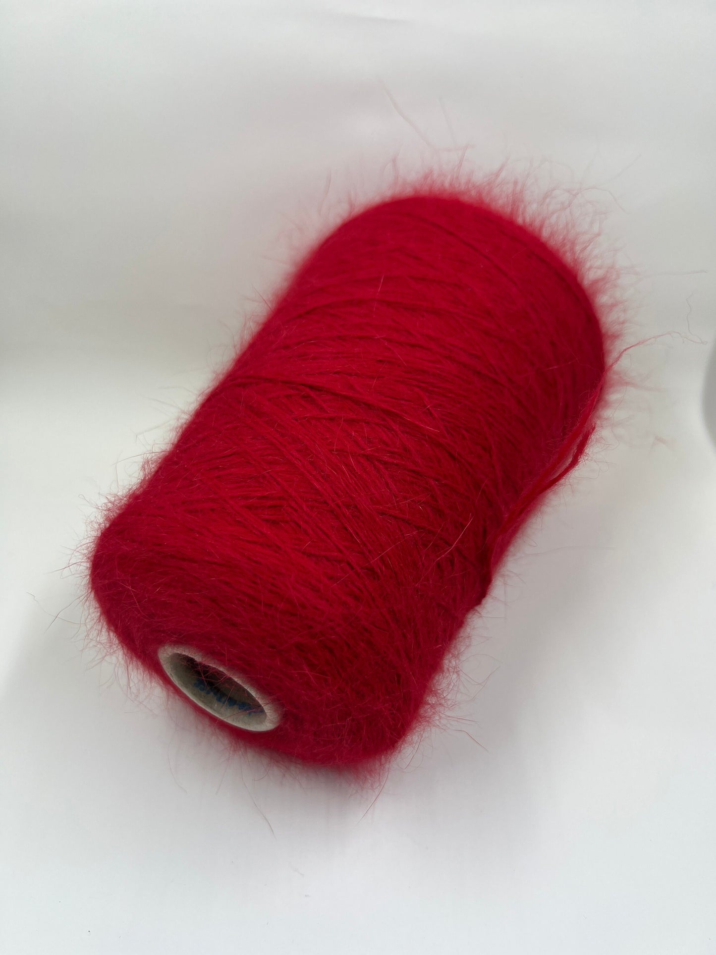 Angora blend Yarn by Profilo. Angora Yarn for Hand & Machine Knitting. Yarn on Cone. Fiber: 80% Angora Yarn & 20% Poliamide. Yarn Colour: Red. Reference: Profilo, Nm 2/10 This is a very soft pure Angora blend yarn by Profilo.