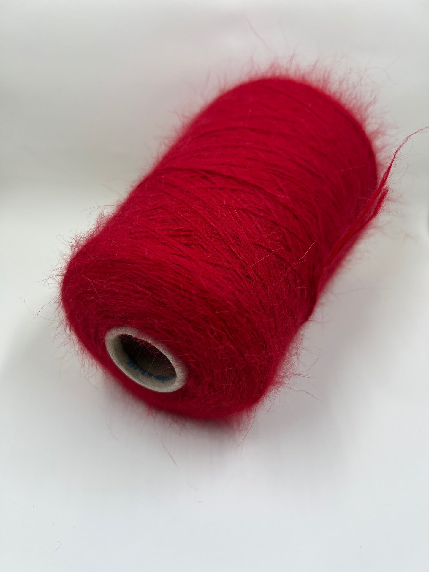 Angora blend Yarn by Profilo. Angora Yarn for Hand & Machine Knitting. Yarn on Cone. Fiber: 80% Angora Yarn & 20% Poliamide. Yarn Colour: Red. Reference: Profilo, Nm 2/10 This is a very soft pure Angora blend yarn by Profilo.