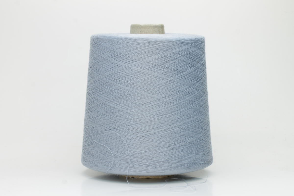 Close-up of pale frost blue 100% cotton yarn, exhibiting a tightly spun 4-ply structure with a soft, uniform sheen and smooth texture.