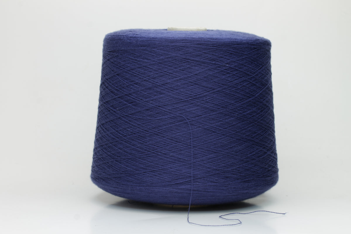 Finely twisted 2-ply cotton yarn in a rich, deep cornflower blue shade, showing a smooth, even texture and subtle natural sheen.