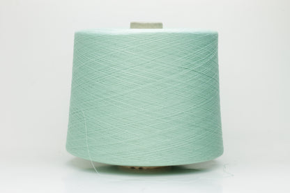 A finely spun, smooth cotton yarn in a delicate pastel mint green color, showing a subtle sheen and tightly plied structure.