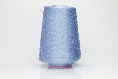 Close-up of extremely fine, single-ply pure silk yarn in a pale, iridescent sky blue. It has a high natural sheen and smooth, uniform texture.
